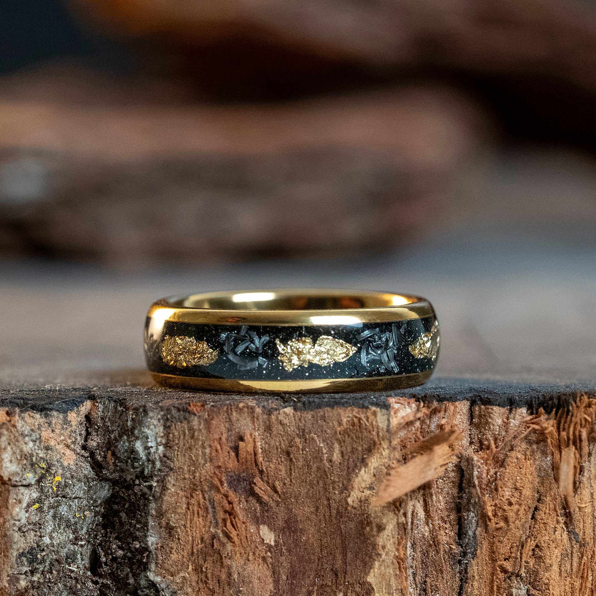 Meteorite x Gold Leaf inlay tungsten carbide ring with 6mm width and polished gold edges on rustic wooden surface