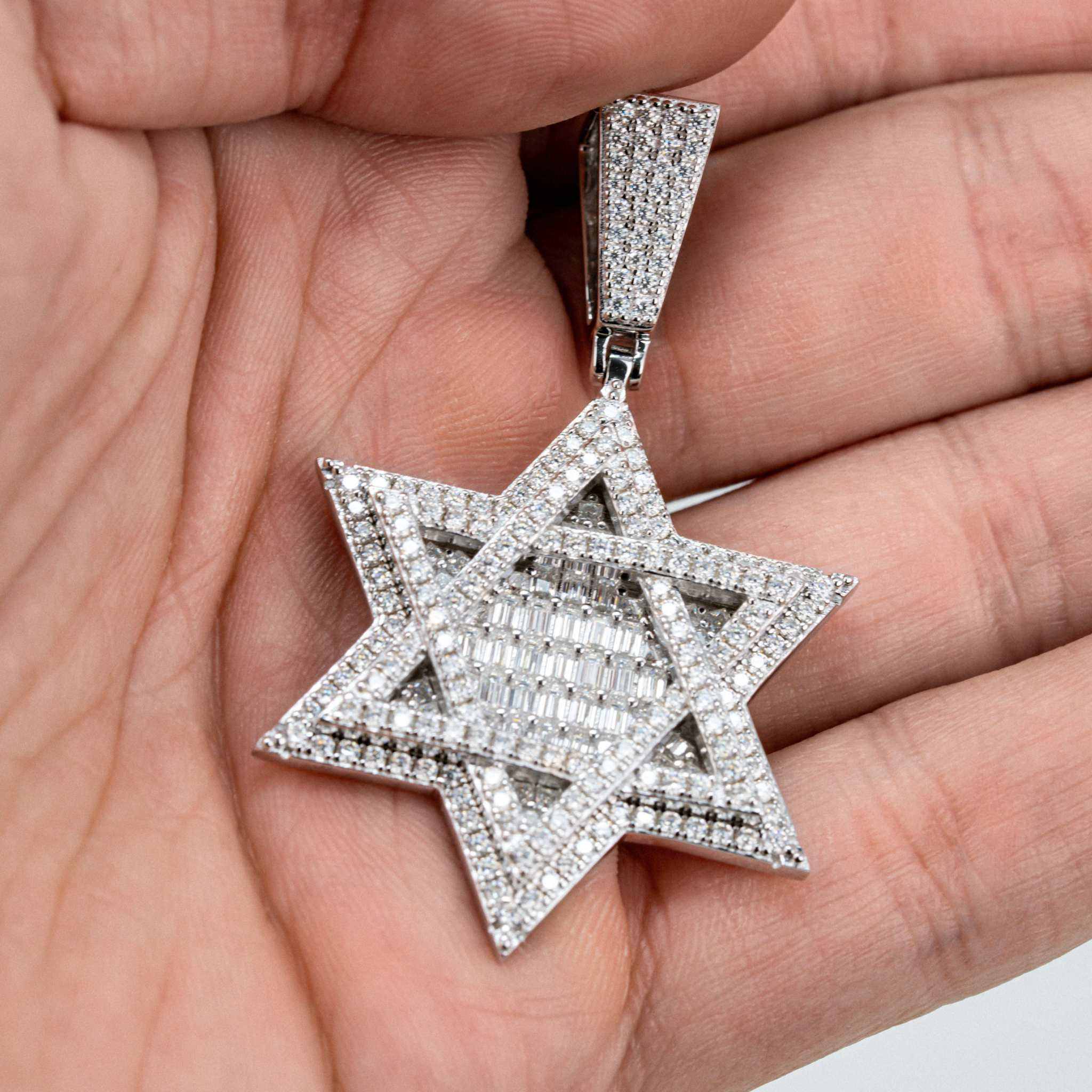 Moissanite Star of David pendant in sterling silver with rhodium plating, featuring round and baguette stones.