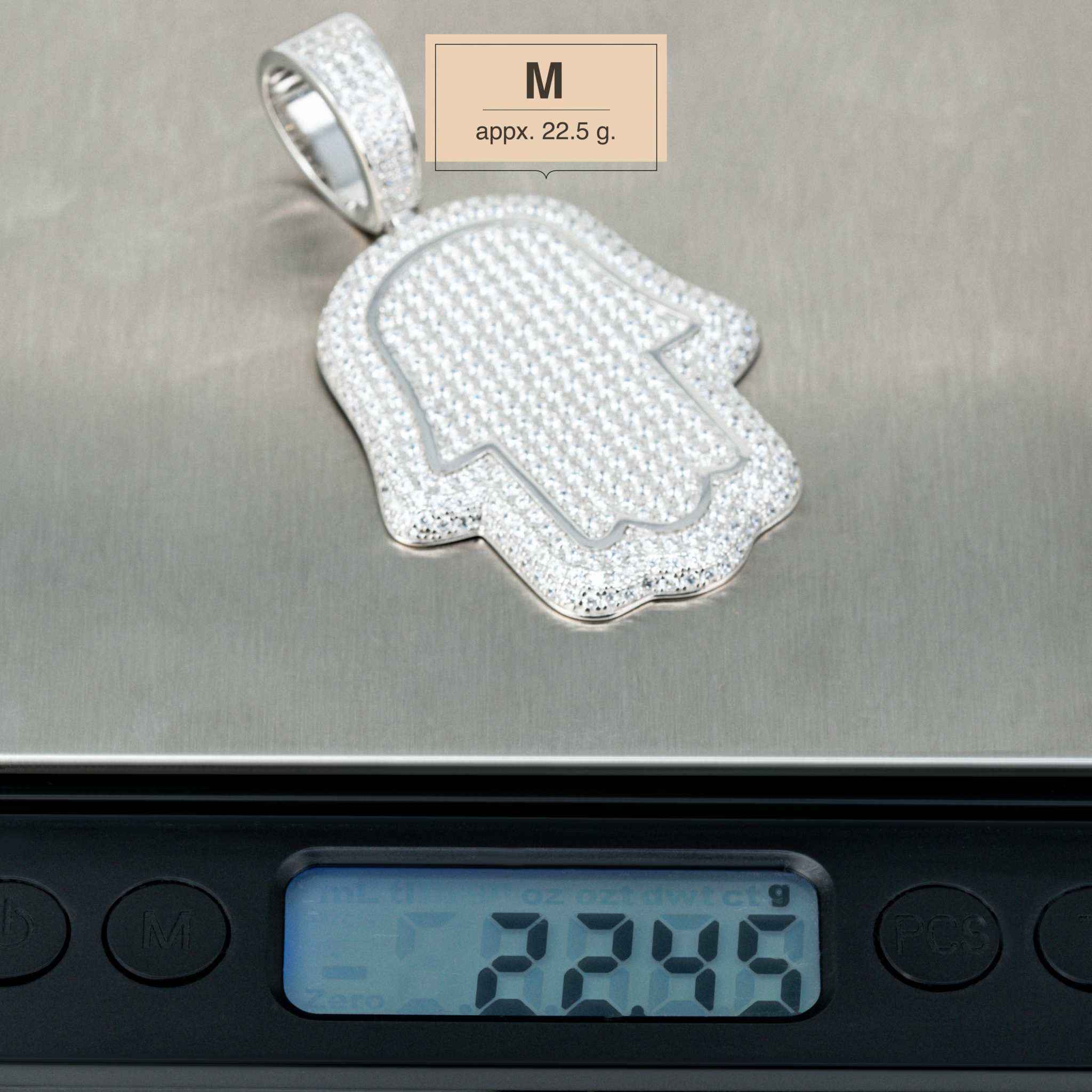 Sterling silver Hand of God Hamsa Pendant on scale, medium size, 22.5g, featuring CZ stones.