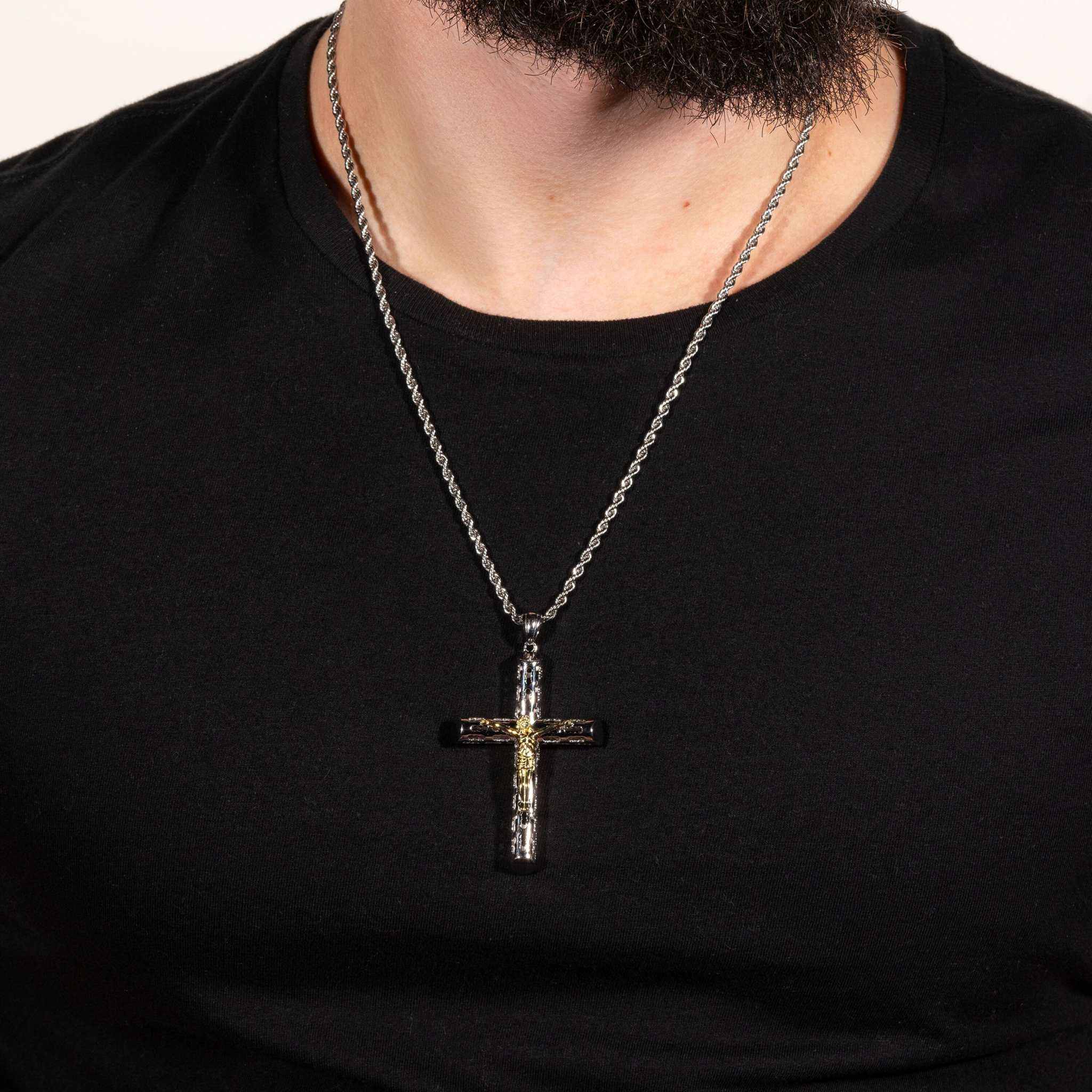 Two tone Jesus crucifix cross pendant in 925 sterling silver with 14K gold plating, worn on a chain.