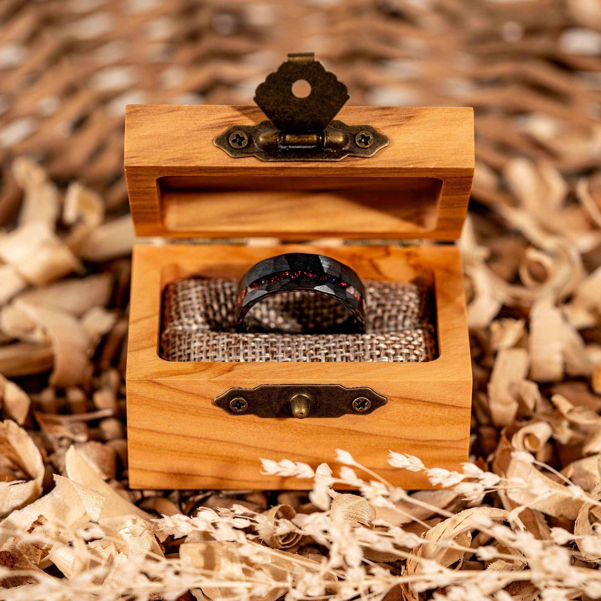 Black Tungsten Opal Ring in a Wooden Box with Decorative Background