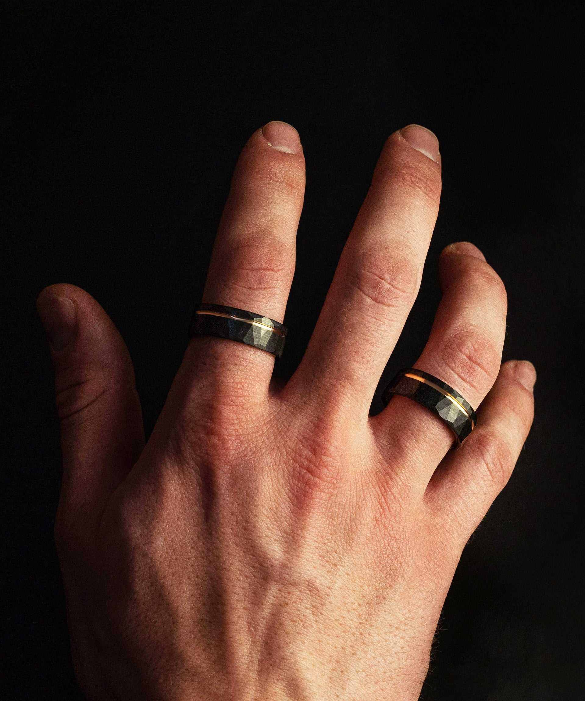 Black tungsten ring on a hand, showcasing its superior quality and comfort-fit design.
