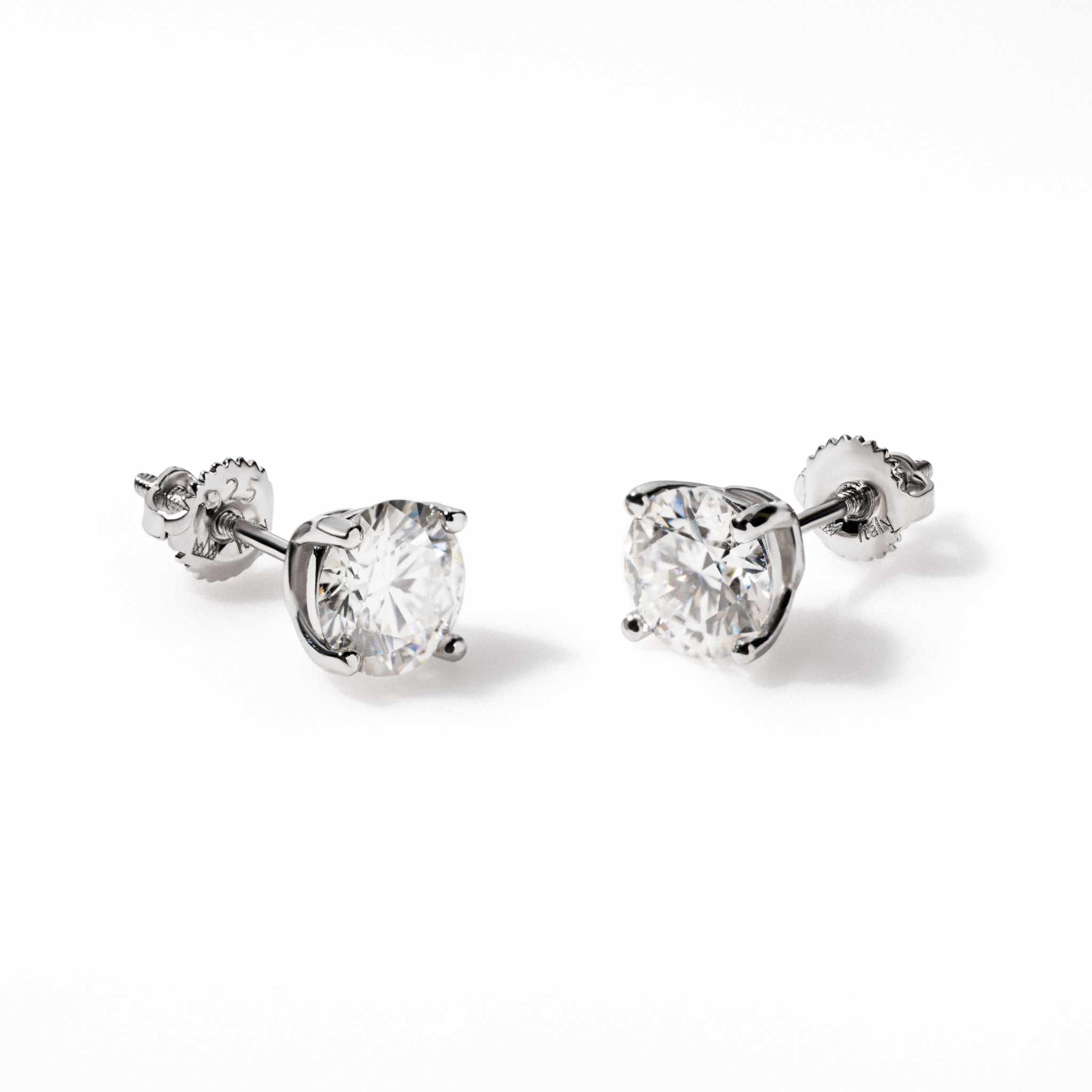 Pair of round cut moissanite stud earrings in 925 sterling silver with screw back closure, white colorless stones, VVS1 clarity, and 14K white gold plating.
