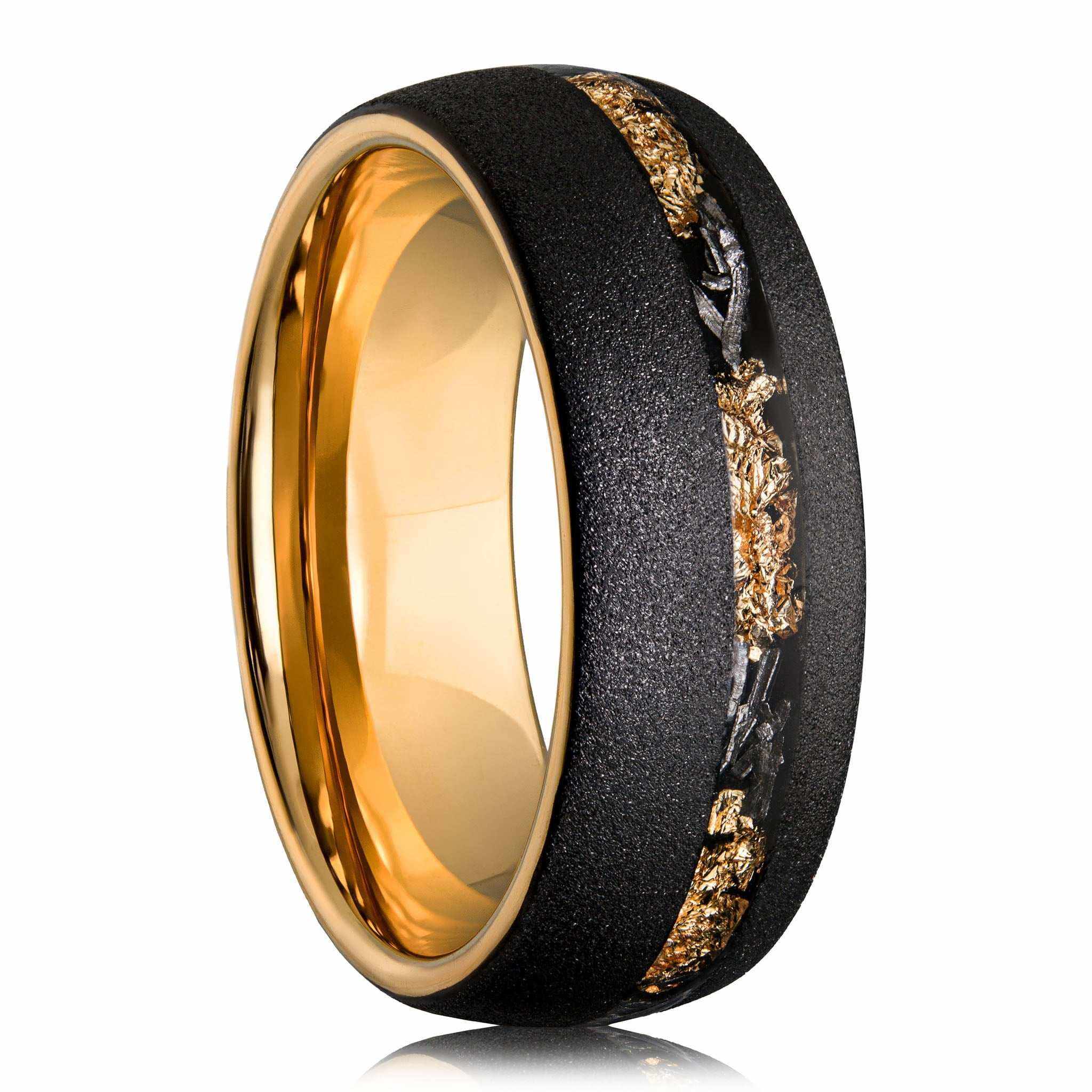 Sandblasted gold leaf meteorite ring with black textured exterior and polished gold interior