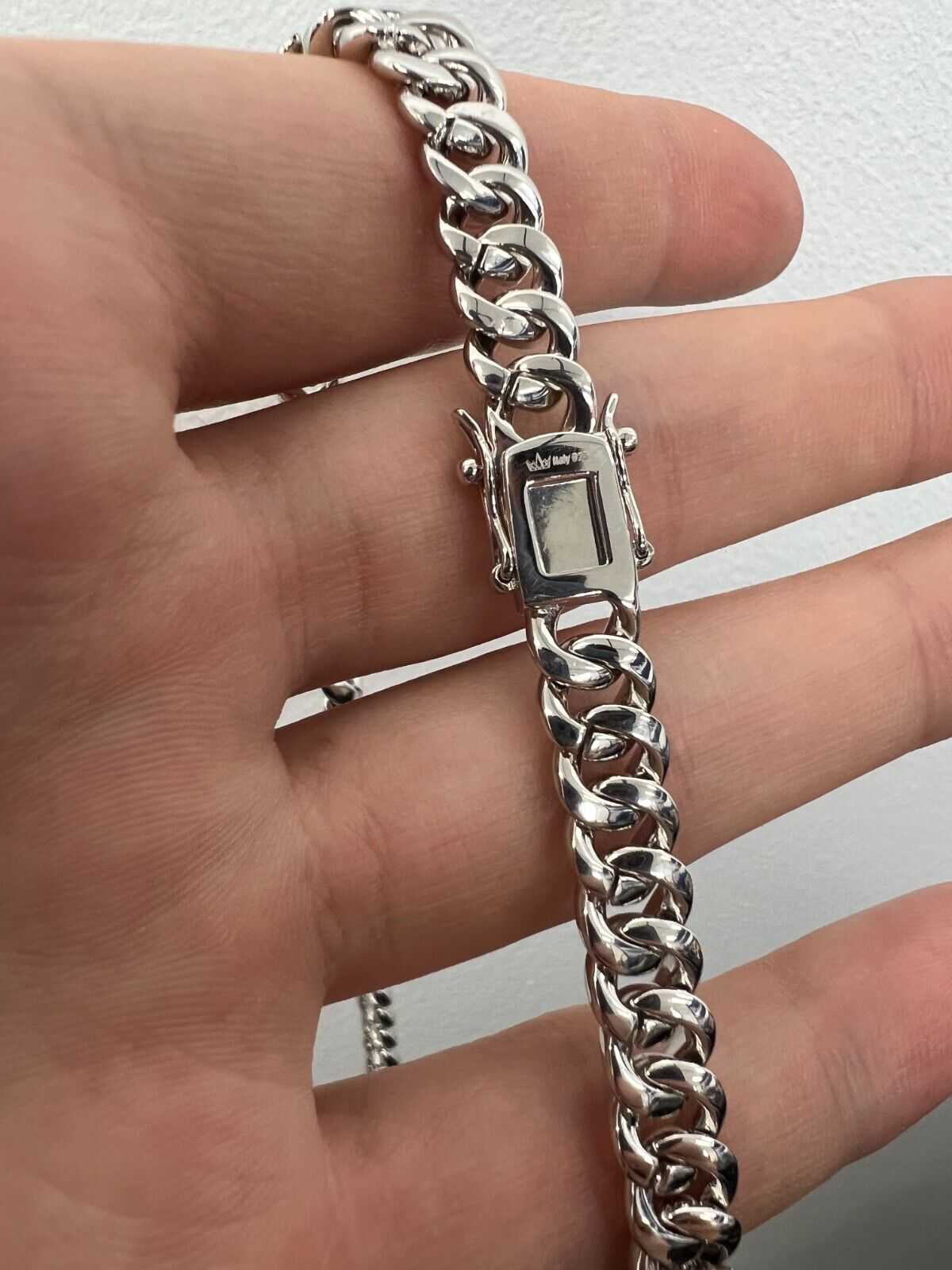 Mens solid 925 sterling silver moissanite Cuban link chain hip hop necklace in hand.