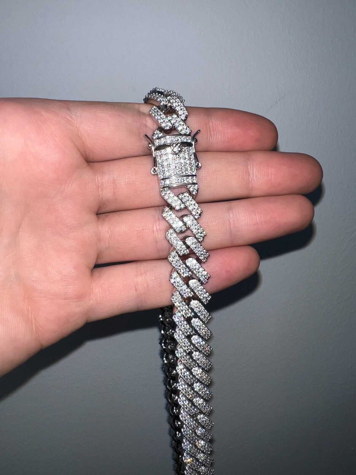 97ct Moissanite Miami Cuban Link Chain in Silver held in hand.