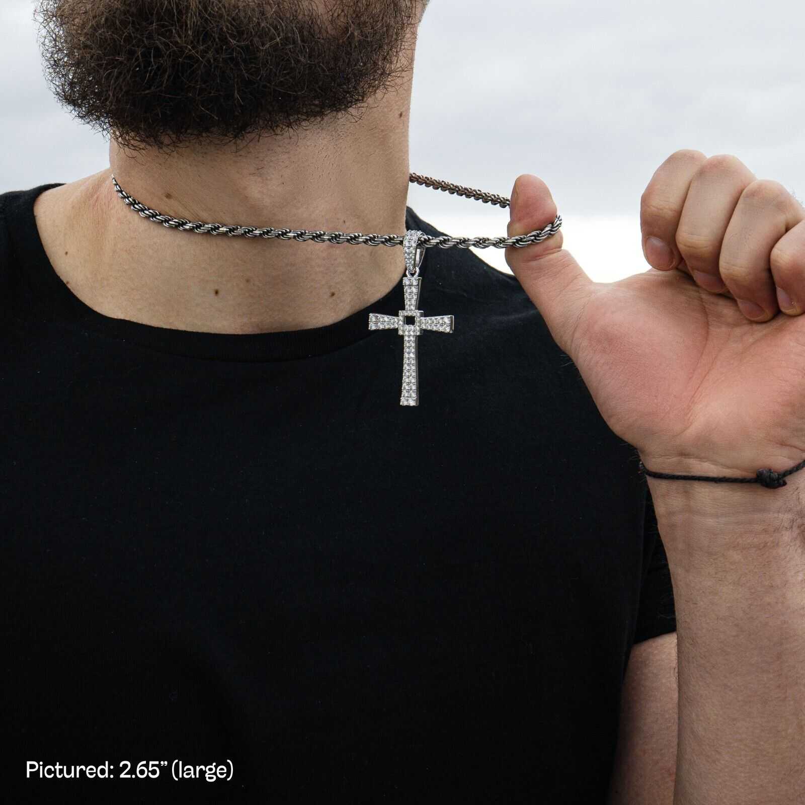 Silver Cross Pendant on chain with man-made diamonds, held by a person, showcasing 925 sterling silver crucifix design.