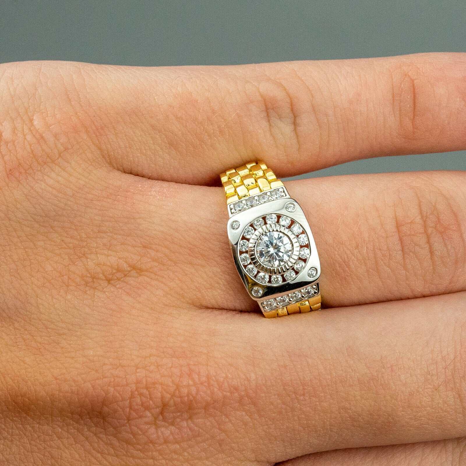 10K gold plated watch ring with cubic zirconia stone on hand.