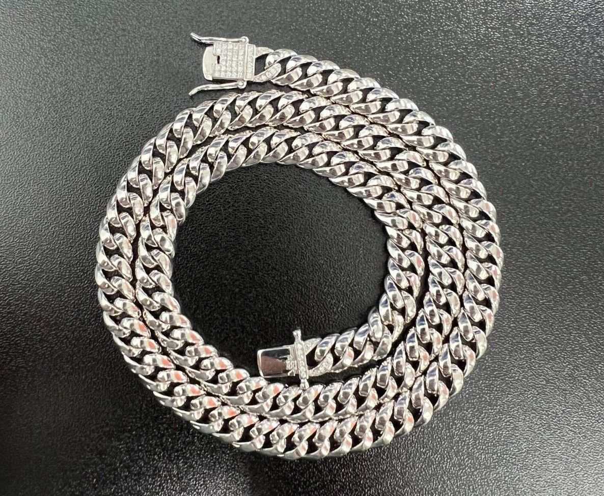 Mens solid 925 sterling silver moissanite Cuban link chain hip hop necklace displayed on a black surface.