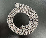 Mens solid 925 sterling silver moissanite Cuban link chain hip hop necklace displayed on a black surface.