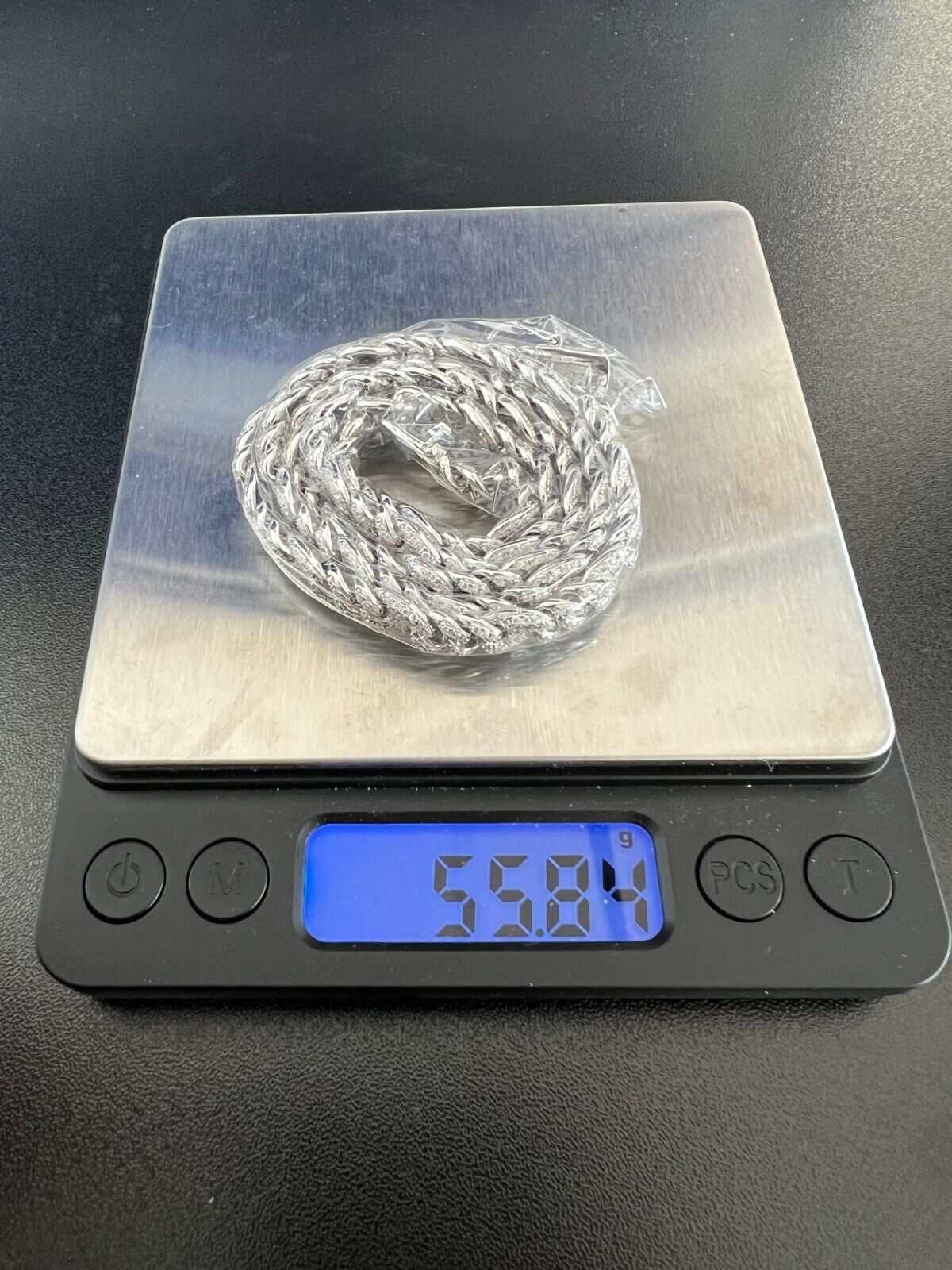 Moissanite Real Miami Cuban Mariner Link Chain on scale displaying weight.