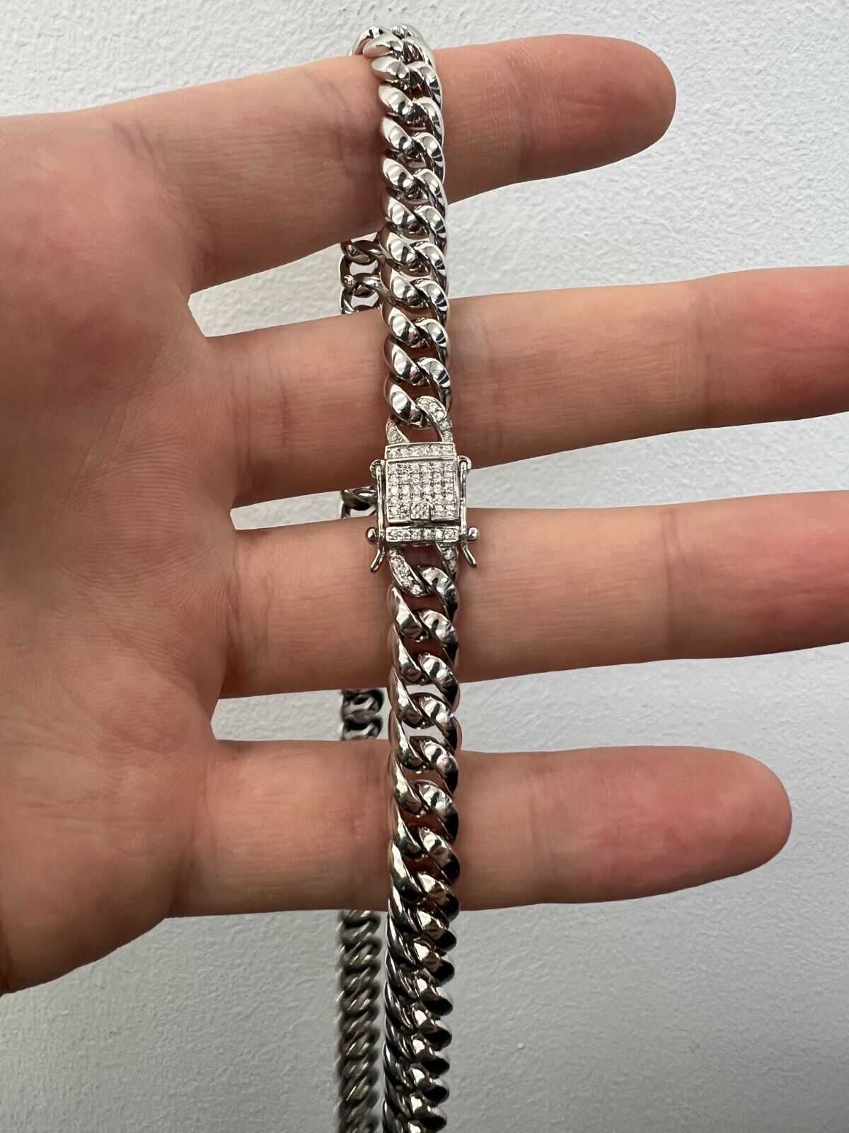 Mens solid 925 sterling silver moissanite Cuban link hip hop necklace in hand.