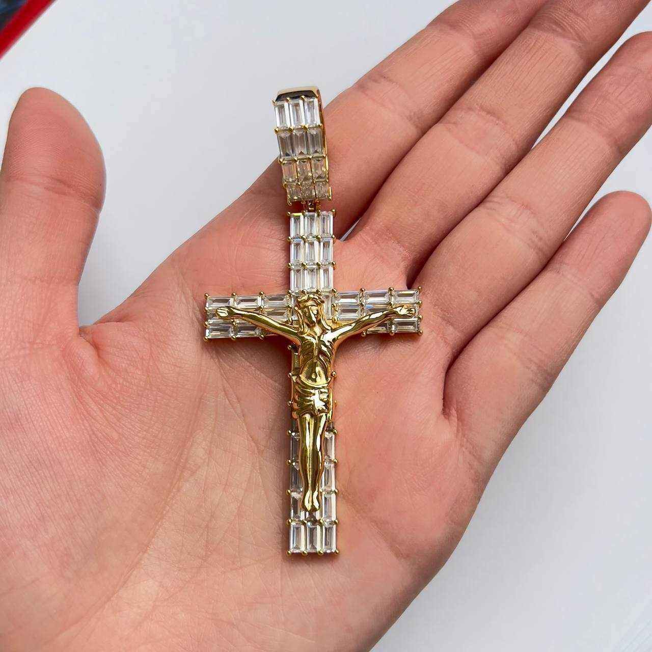 14K gold finish Jesus crucifix pendant with cubic zirconia on hand.