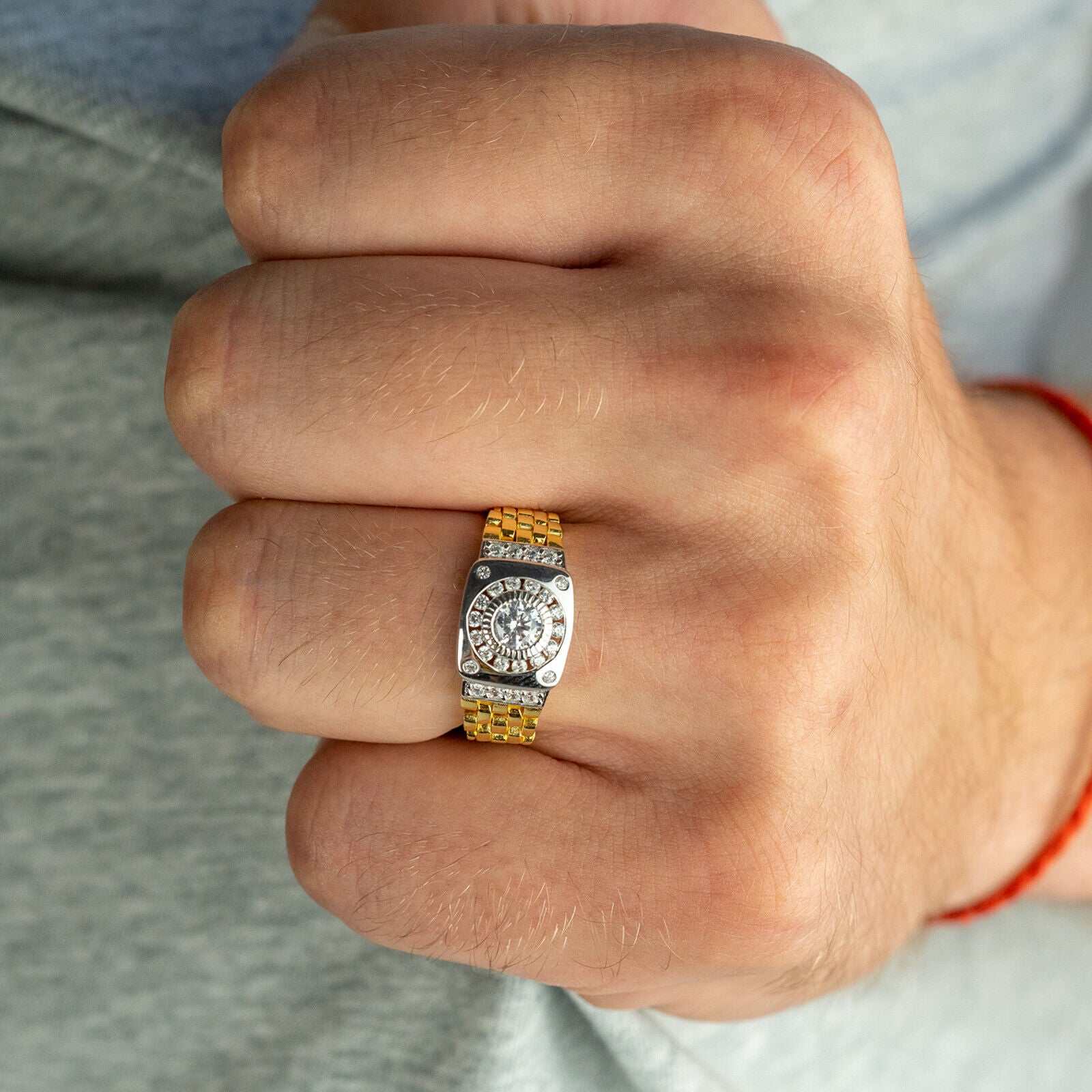 10K gold-plated watch ring with cubic zirconia stone on finger.