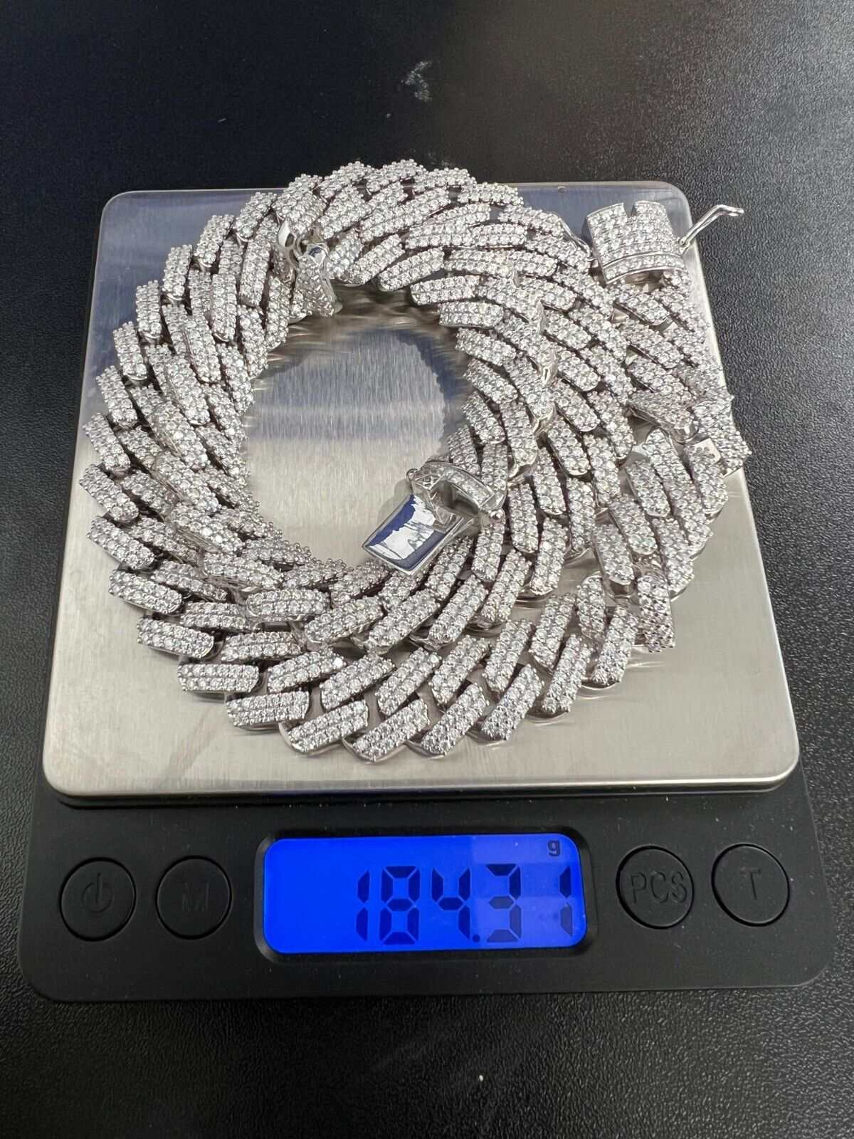 97ct Moissanite Miami Cuban Link Chain Iced Hip Hop 925 Silver Necklace on scale displaying weight.