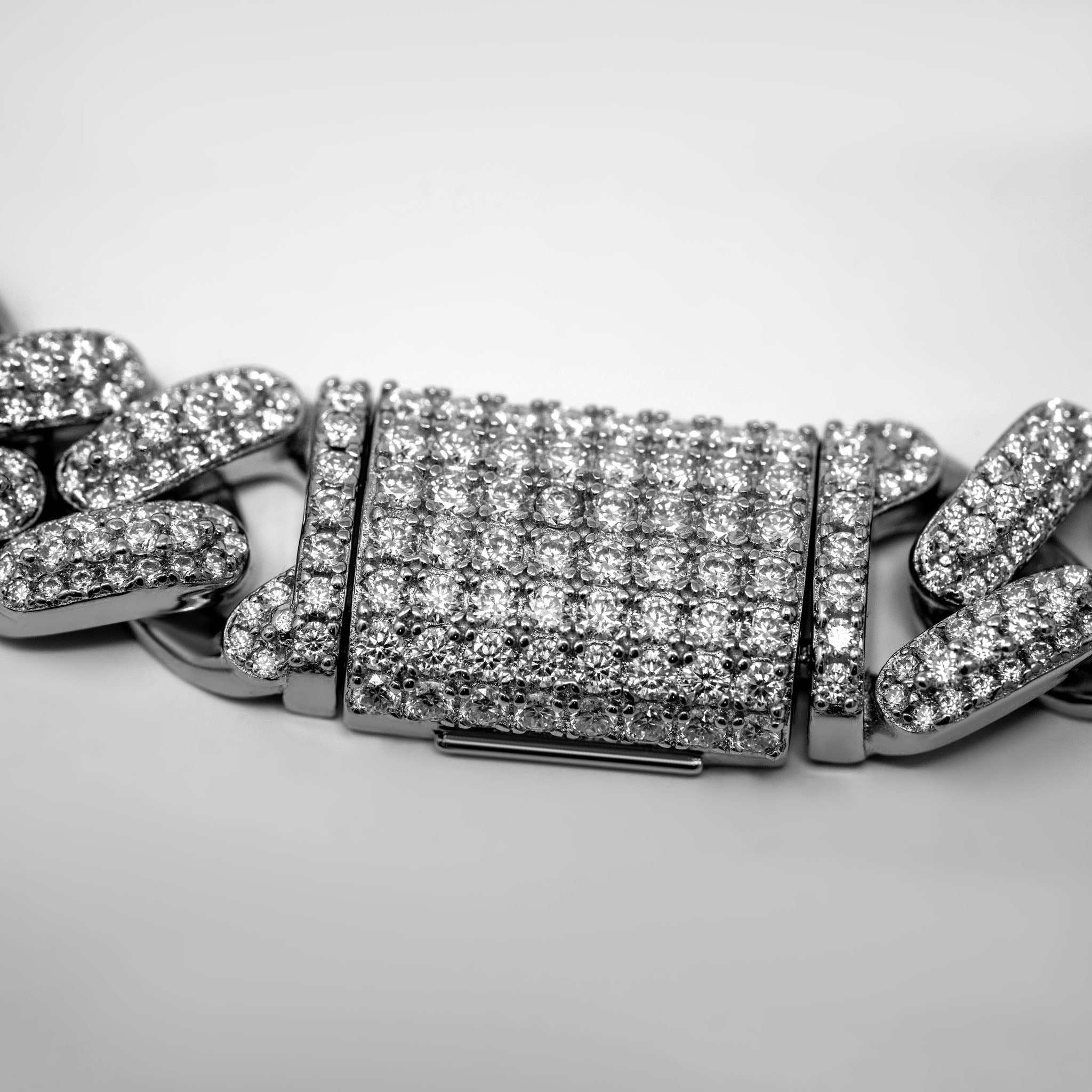 12mm Moissanite Miami Cuban Link Chain in sterling silver with moissanite stones.