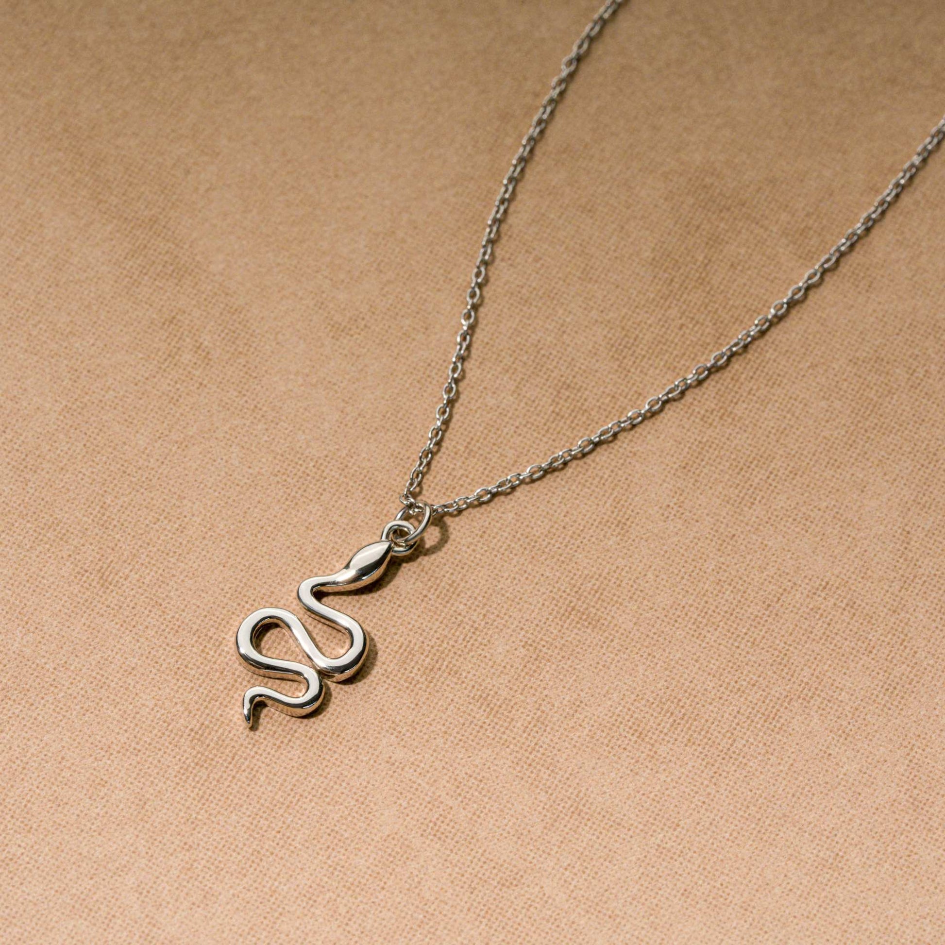 Snake necklace with a 17x9mm pendant on adjustable chain in sterling silver or 14K gold.