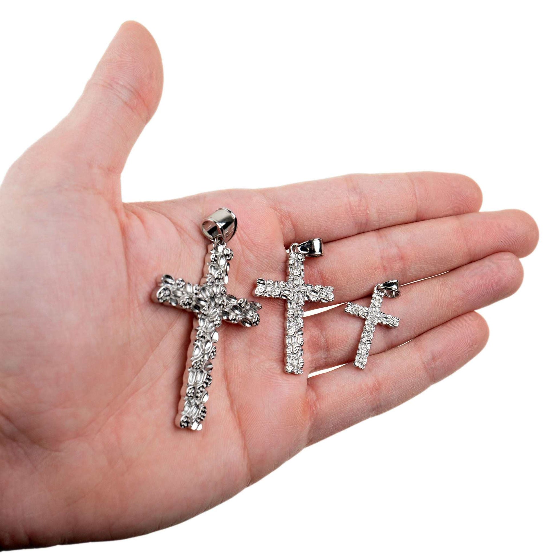 Silver Nugget Cross Pendant in three sizes displayed on a hand.