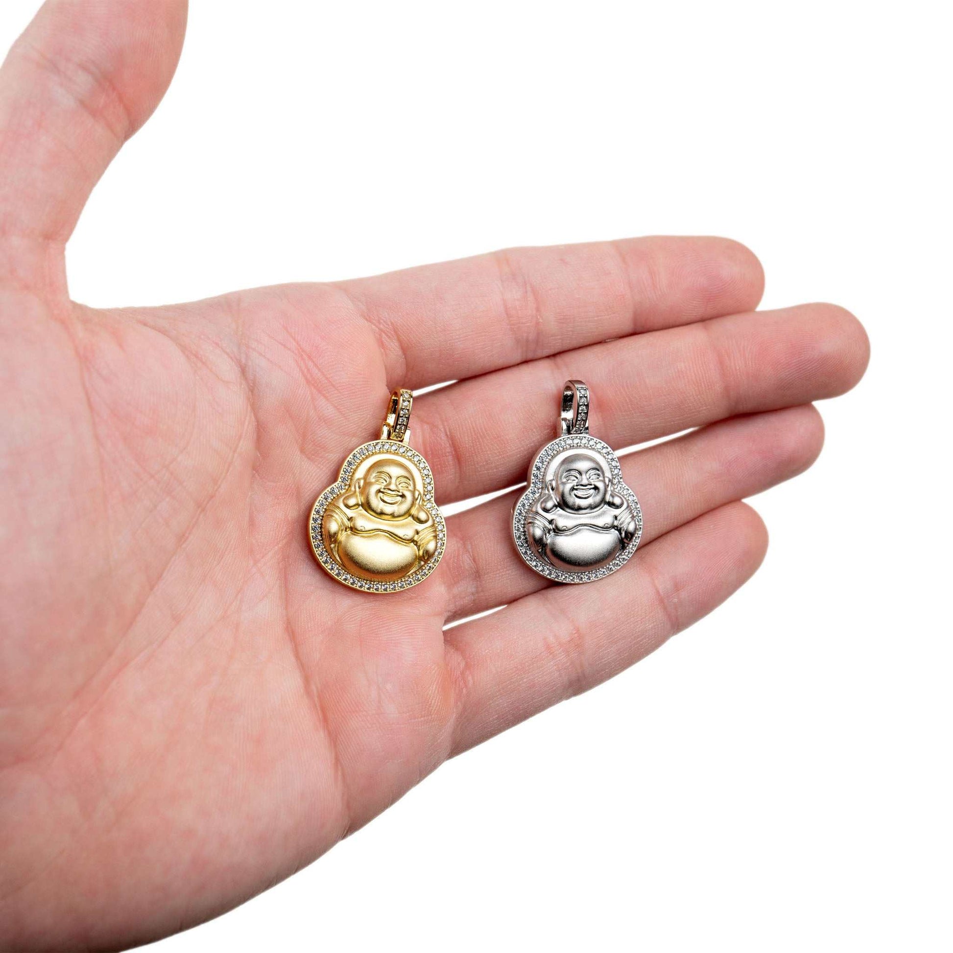 Buddha Pendant in gold and silver held in a hand, showcasing intricate design and micropaved diamonds.