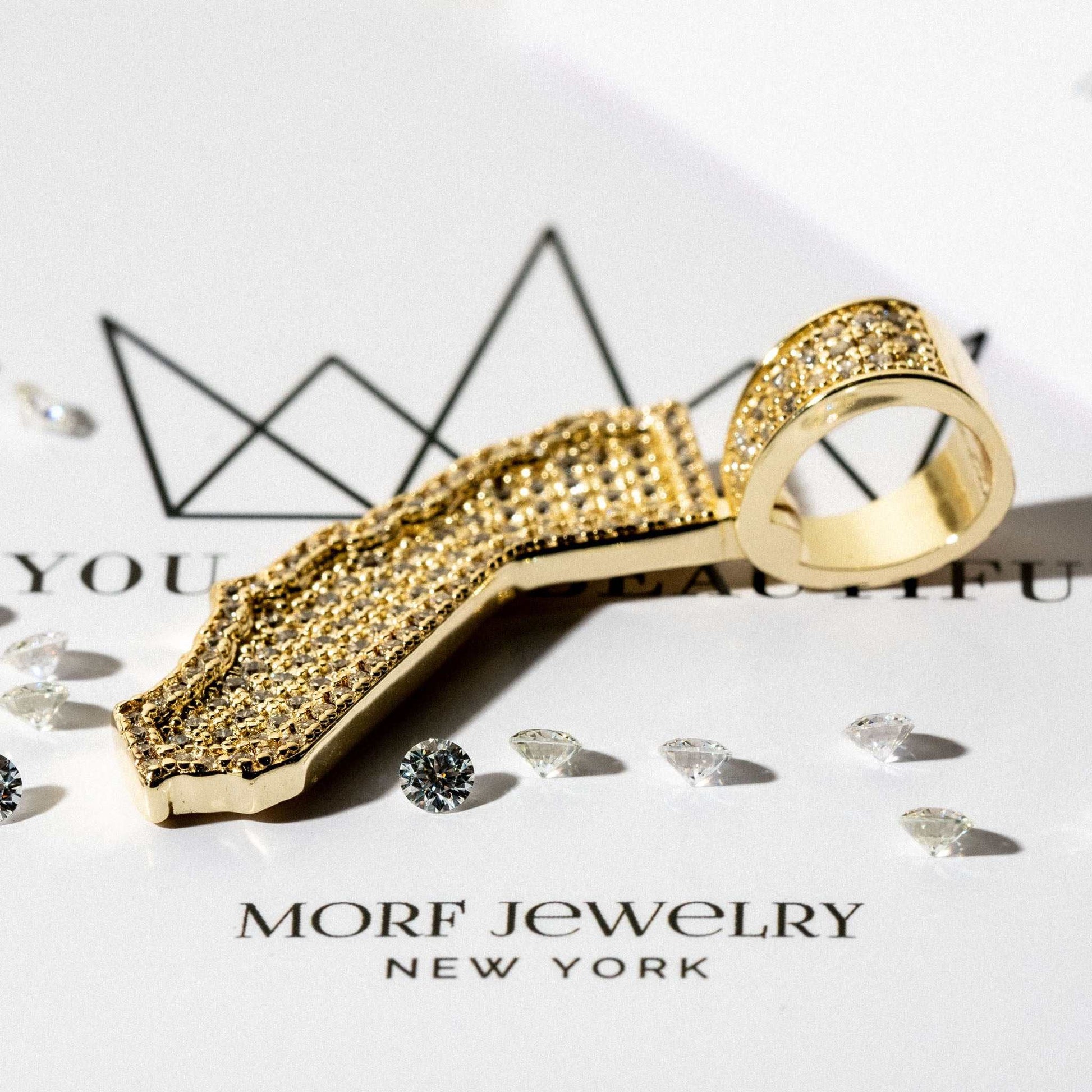 California state pendant in gold plating with man-made diamonds on a jewelry card.