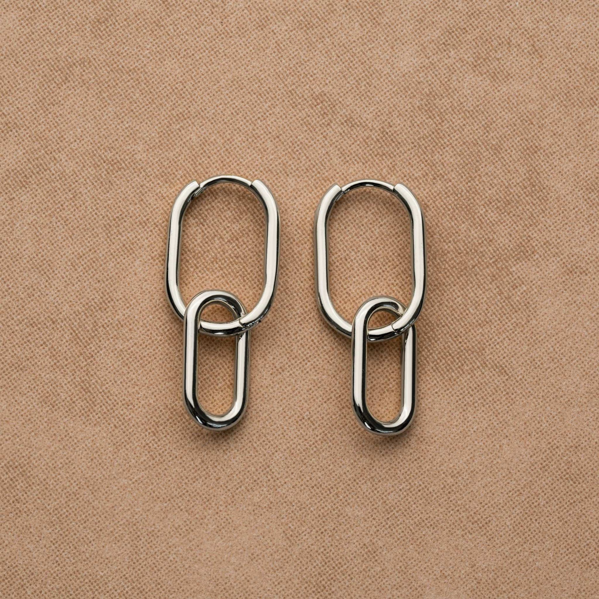 Sterling silver link earrings with a minimalist chain design and rhodium finish.