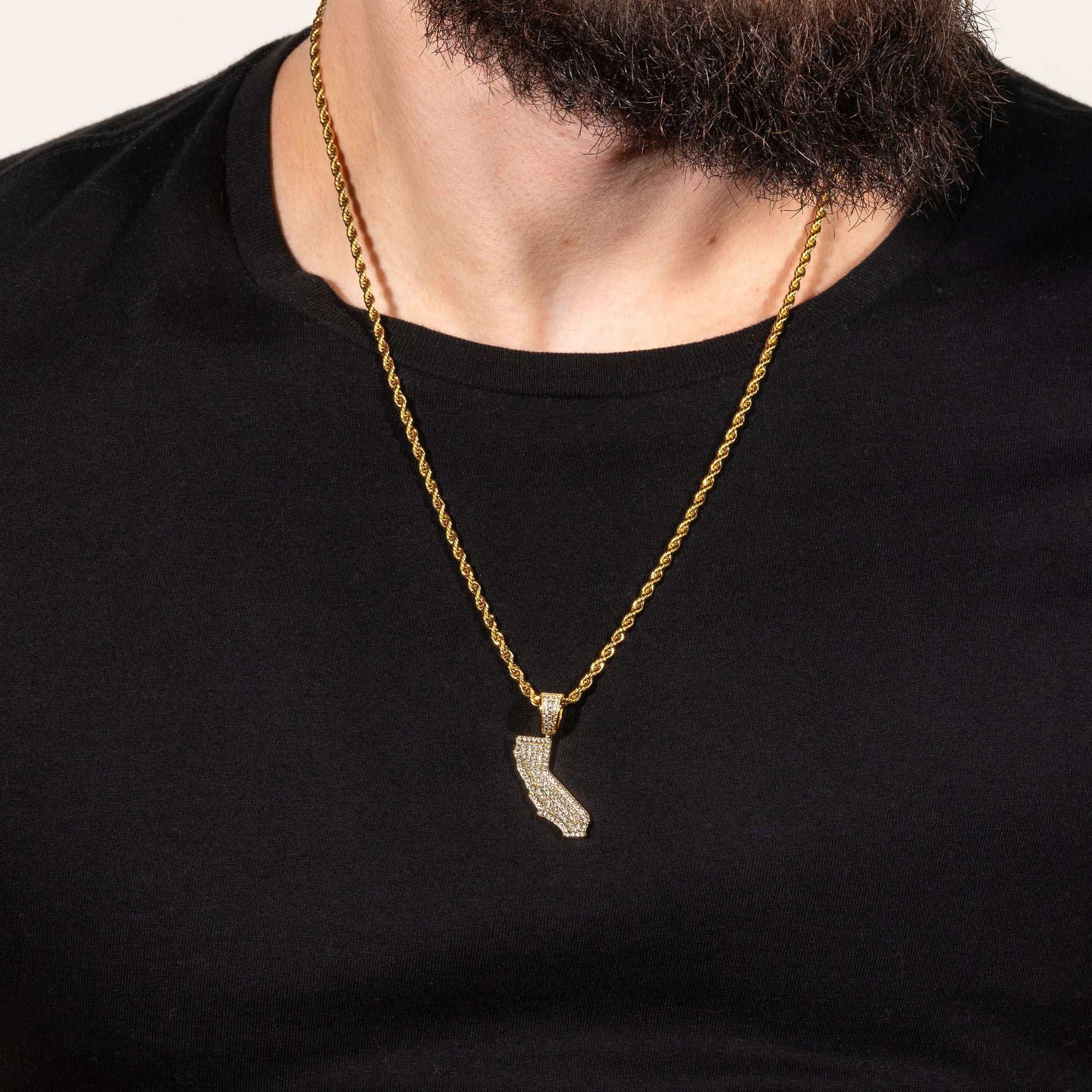 California State Pendant in gold on a necklace, featuring man-made diamonds, worn by a person in a black shirt.