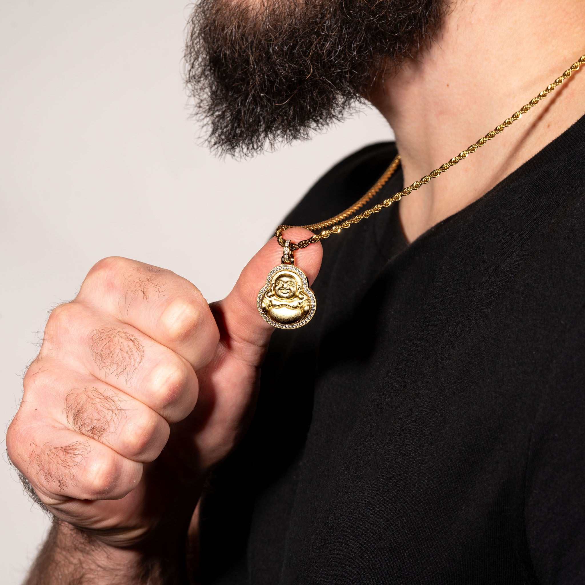 Man wearing Buddha pendant made of 925 sterling silver with micropaved CZ stones in gold finish.