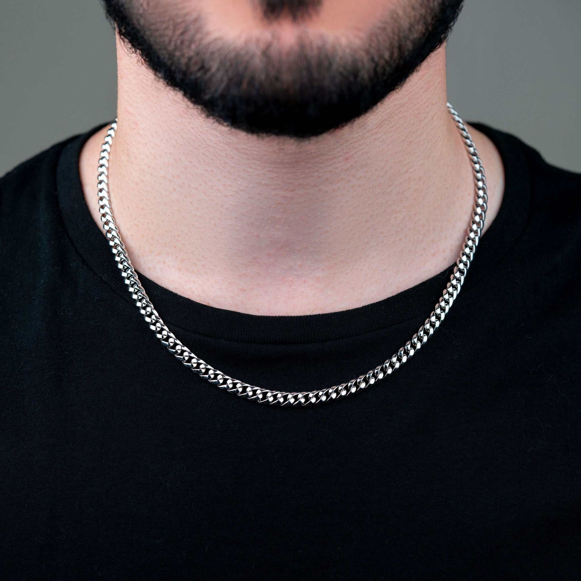 6MM Miami Cuban Link Chain on person; 925 sterling silver, moissanite stones, 20 or 24-inch length.