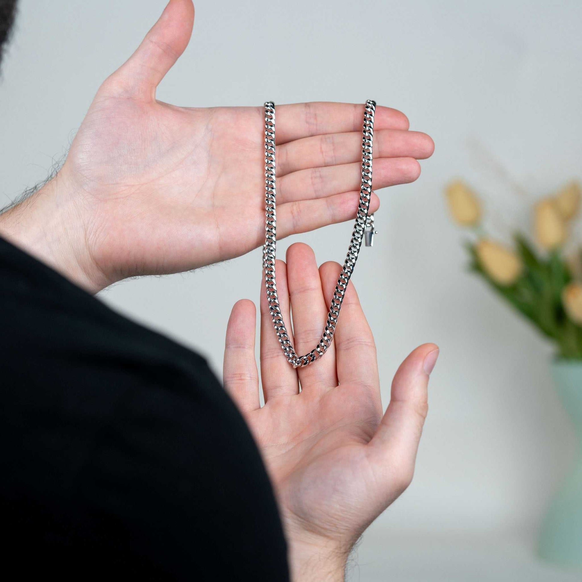 6MM Miami Cuban Link Chain in hand, sterling silver with moissanite stones.