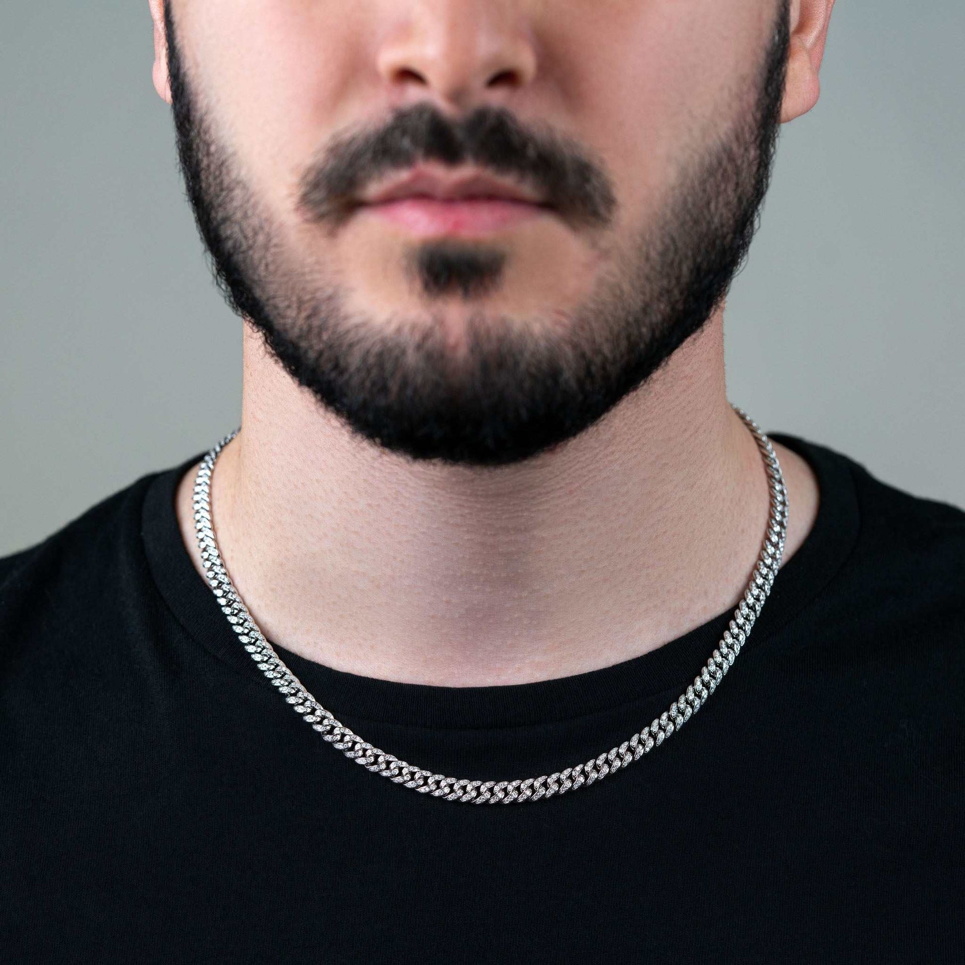 6MM Iced Moissanite Miami Link Chain on person, 925 Sterling Silver, unisex design.