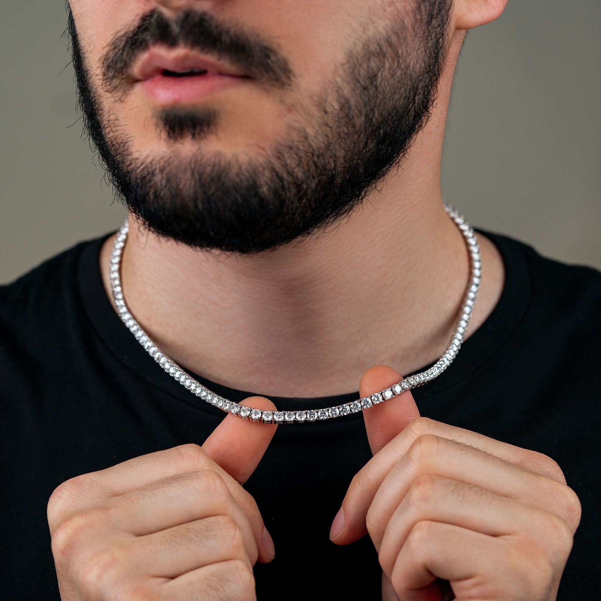 Man wearing 4mm Moissanite Tennis Chain in sterling silver on black shirt.