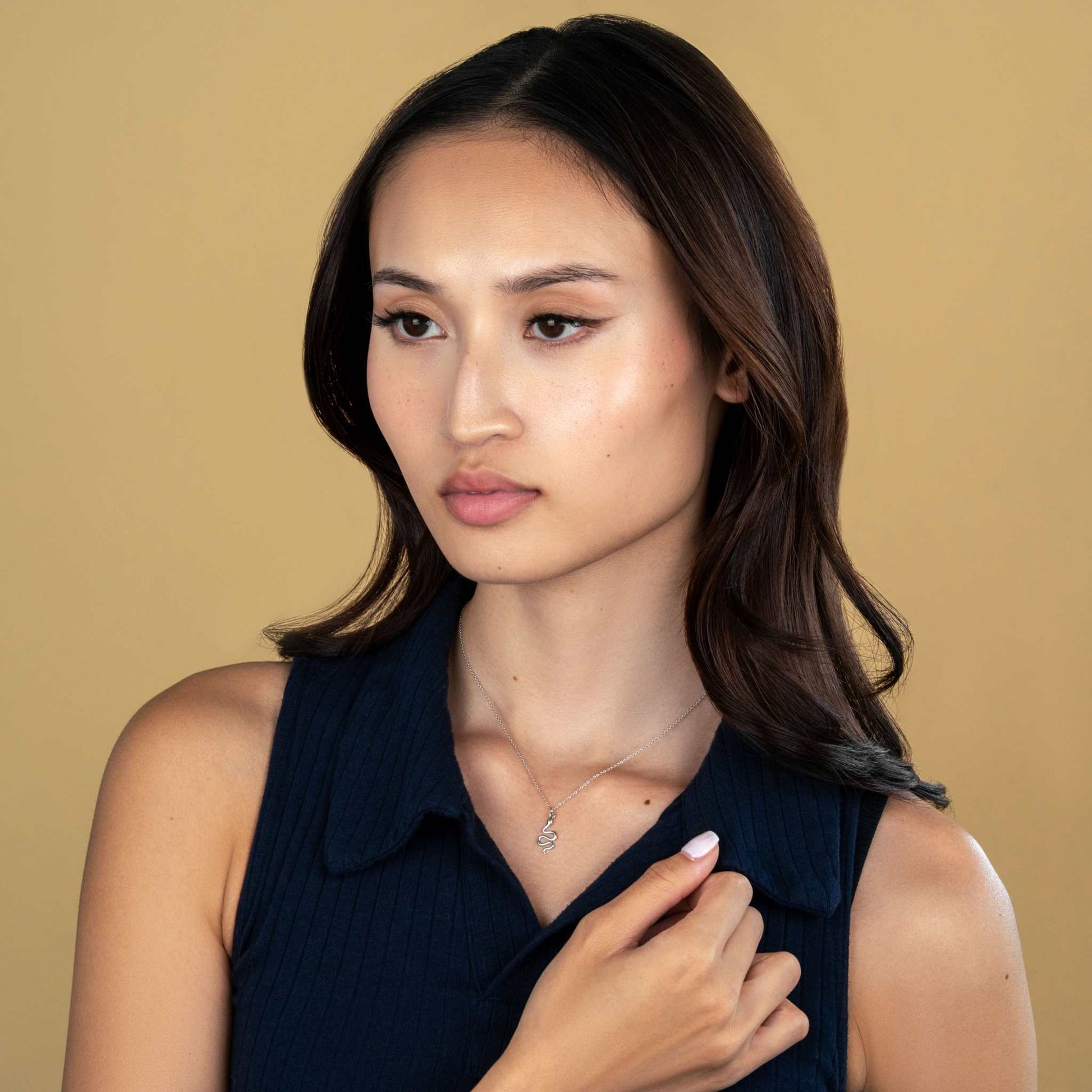 Woman wearing snake necklace with adjustable chain, symbolizing transformation and rebirth.