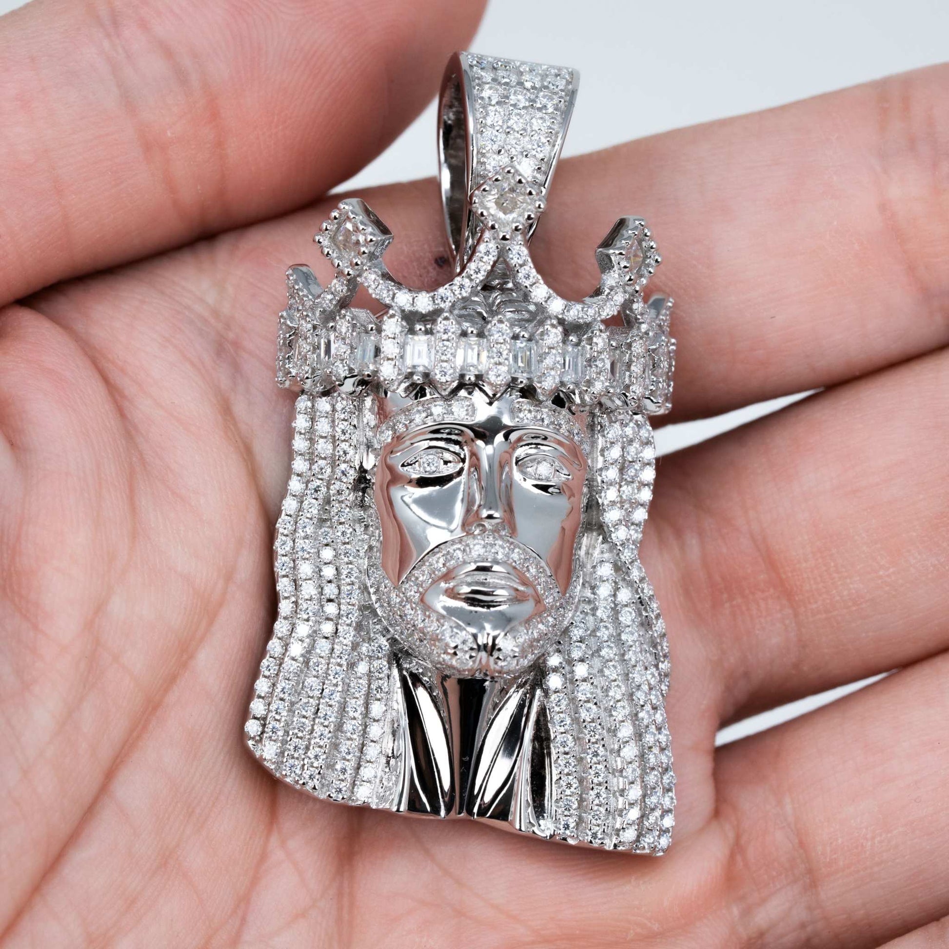 Moissanite iced king crown Jesus head pendant in sterling silver displaying intricate design and brilliance.