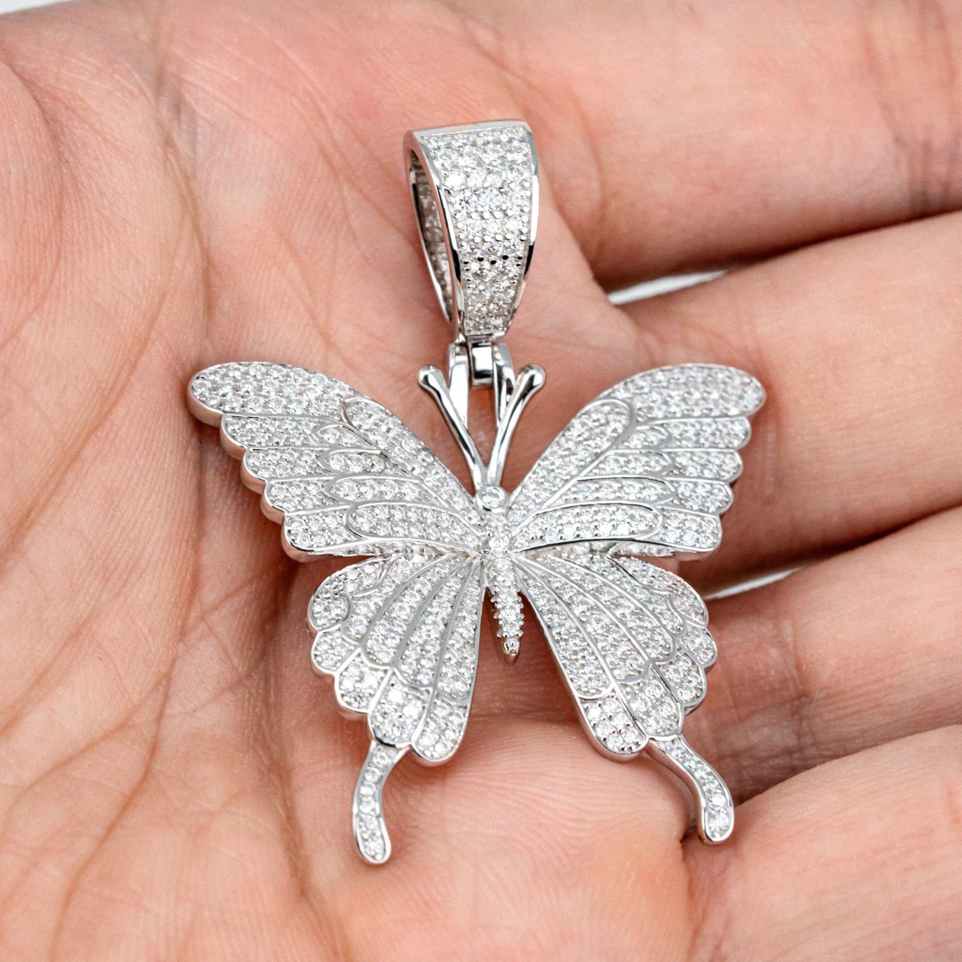 Womens Moissanite Butterfly Pendant in 925 sterling silver with pave-set stones.