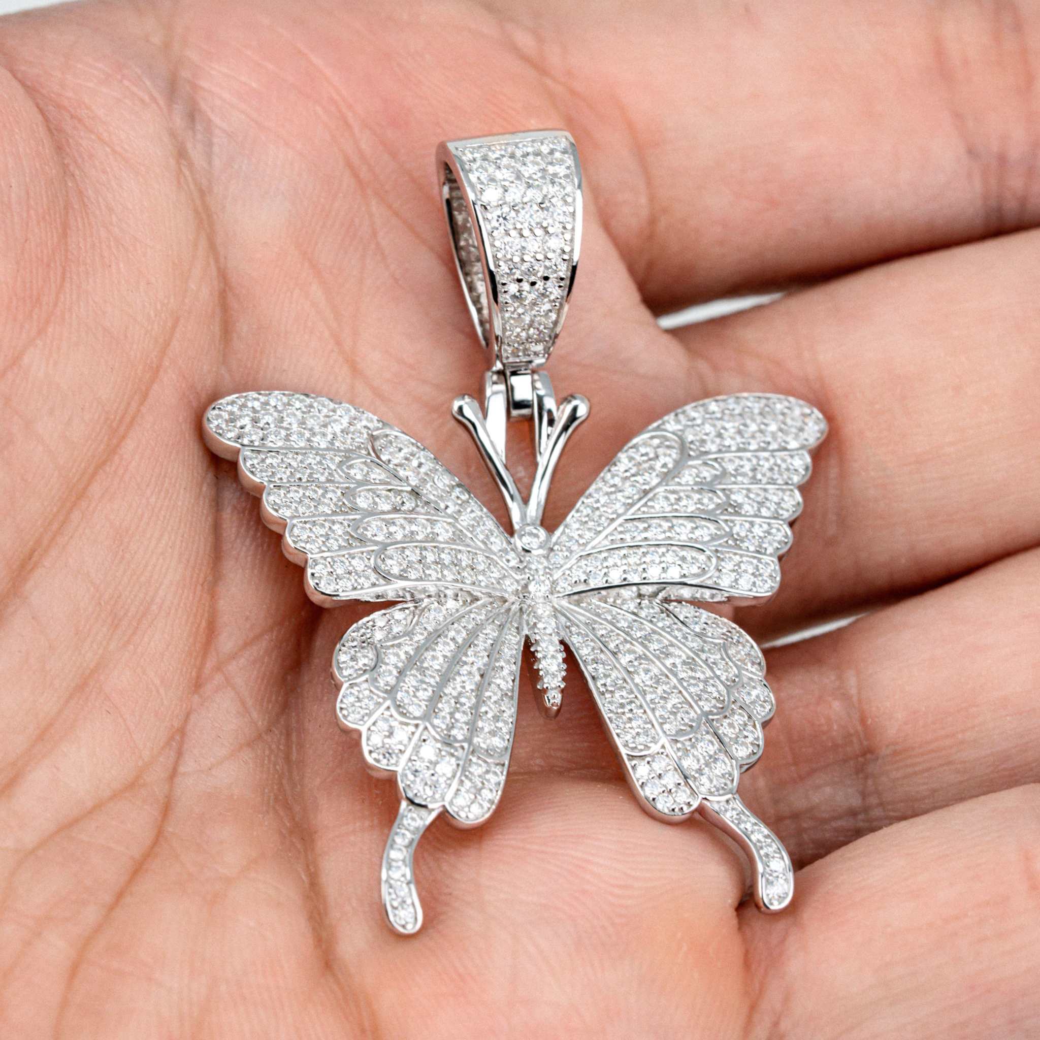 Womens Moissanite Butterfly Pendant in 925 sterling silver with pave-set stones.