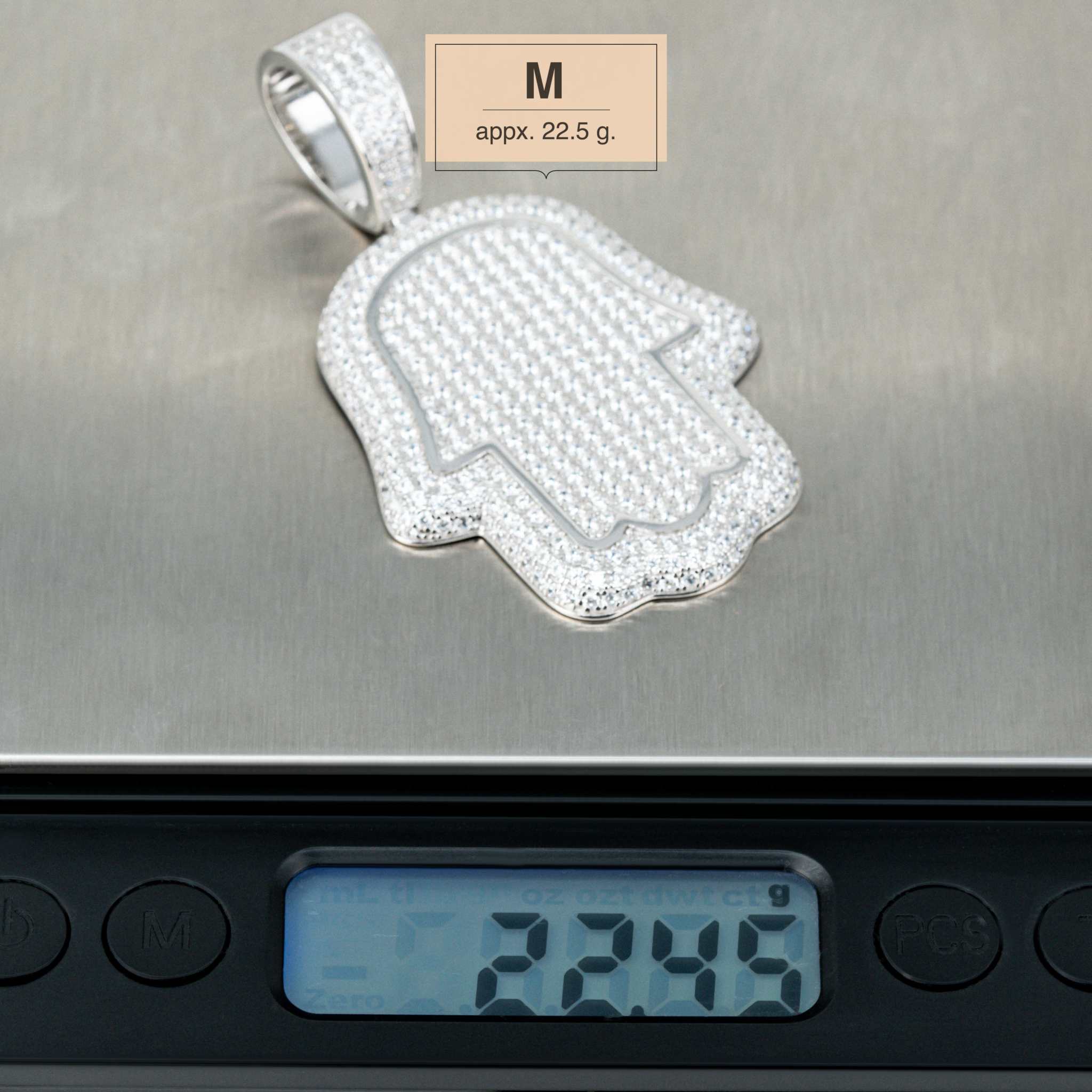 Sterling silver Hand of God Hamsa Pendant on scale, medium size, 22.5g, featuring CZ stones.
