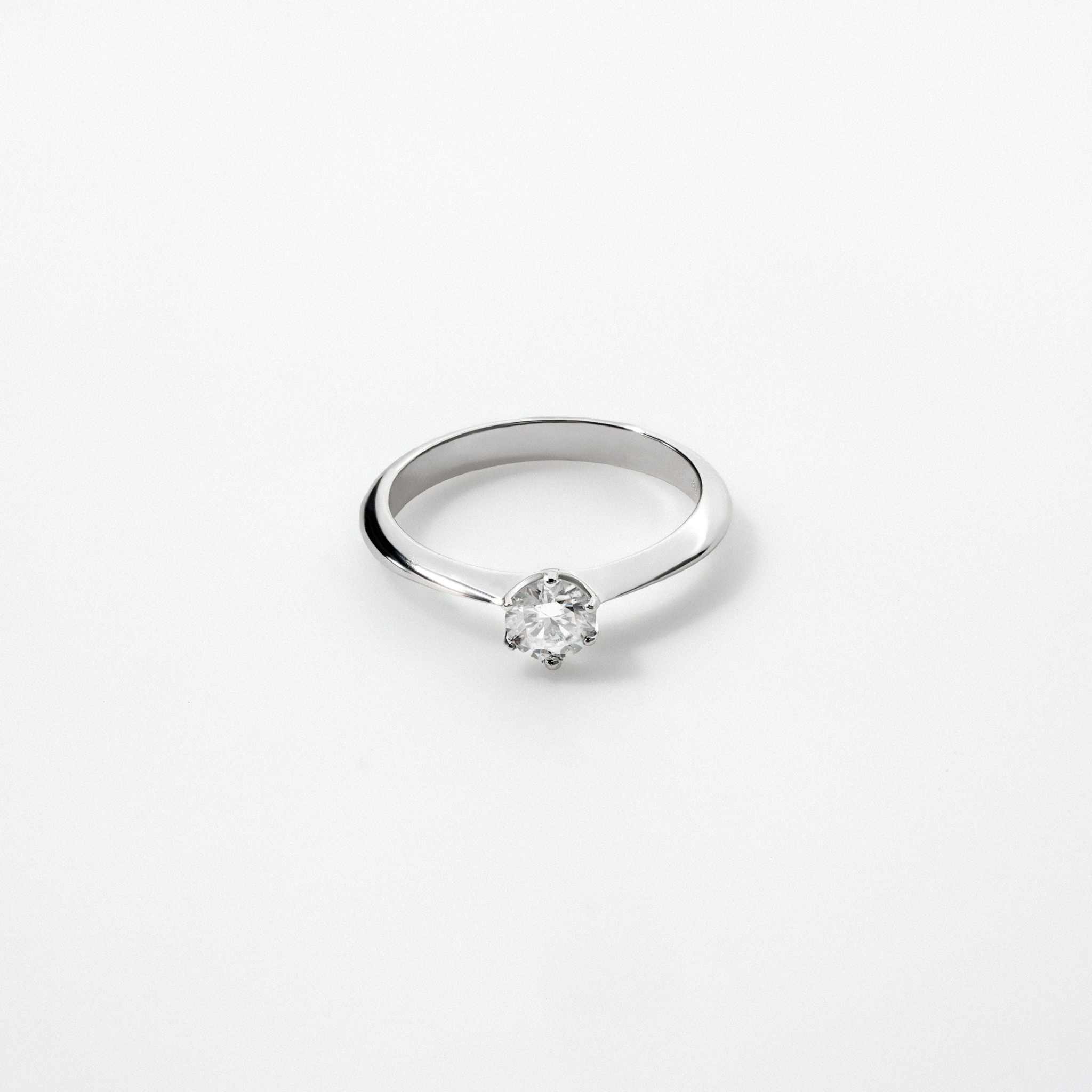 Moissanite Solitaire Engagement Ring in 925 Sterling Silver, six-prong round cut.