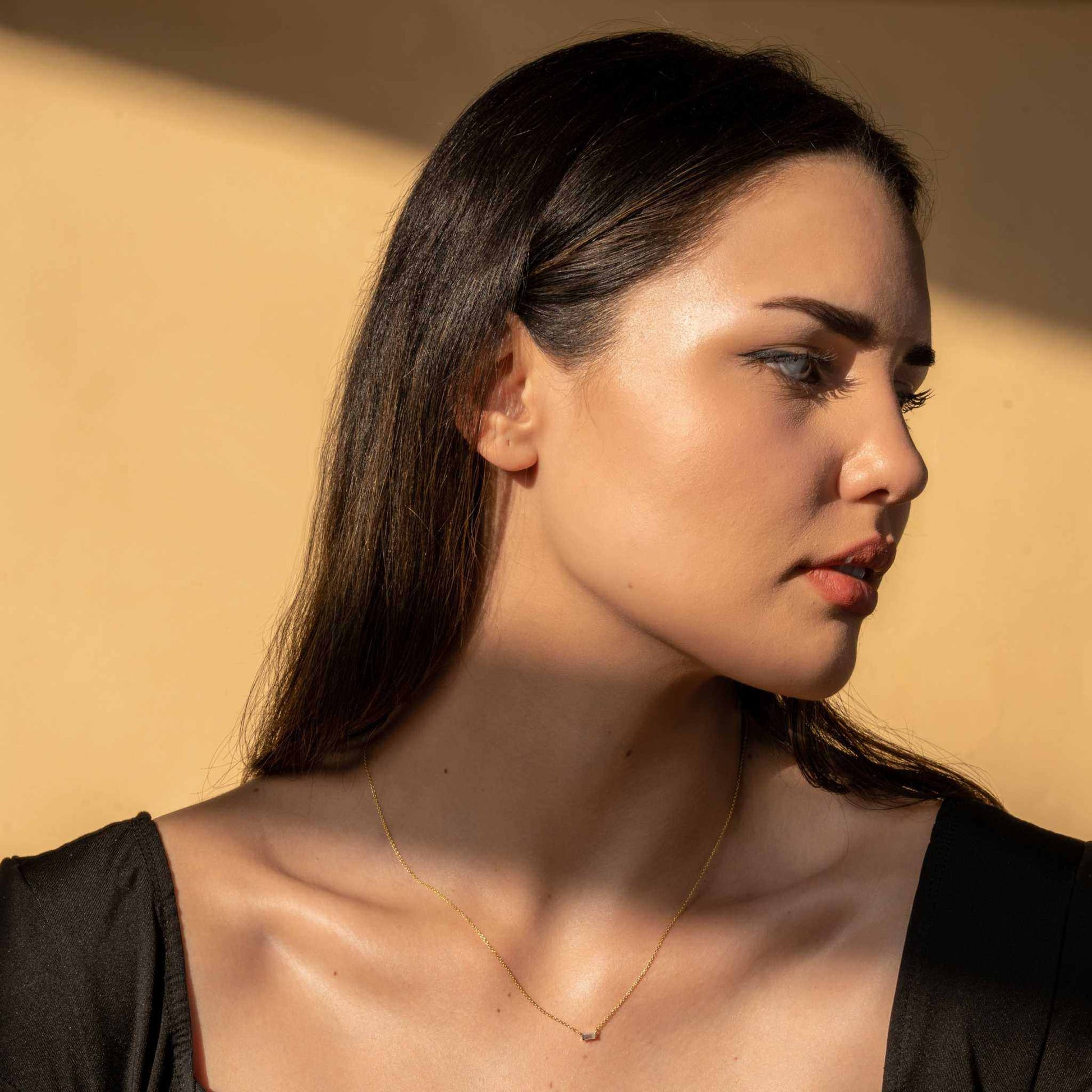 Elegant Baguette Sparkle Necklace on model, 925 Sterling Silver with clear CZ pendant, adjustable chain.