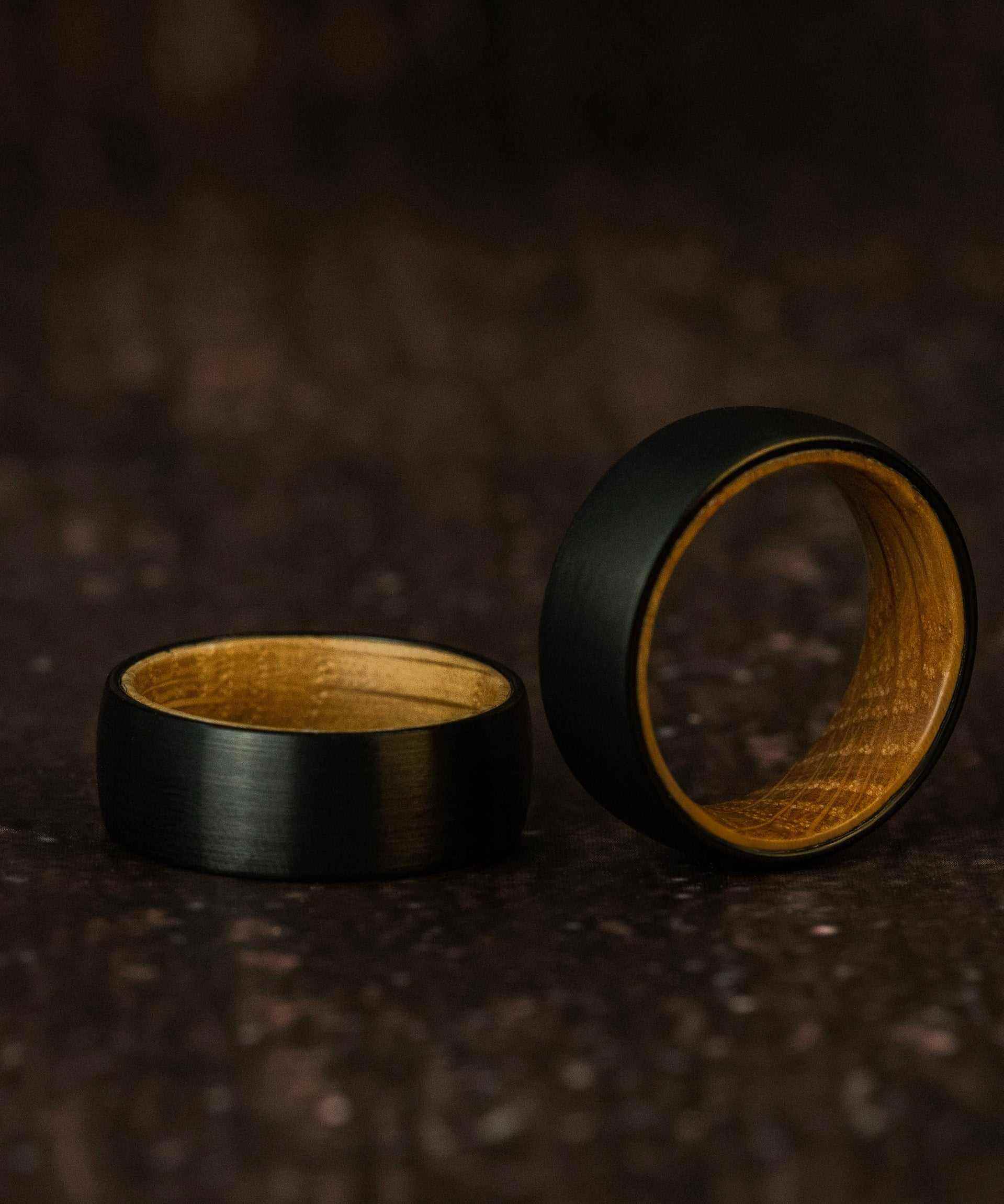 Black satin finish tungsten ring with olive wood inner band, unisex style, plain whiskey barrel design.