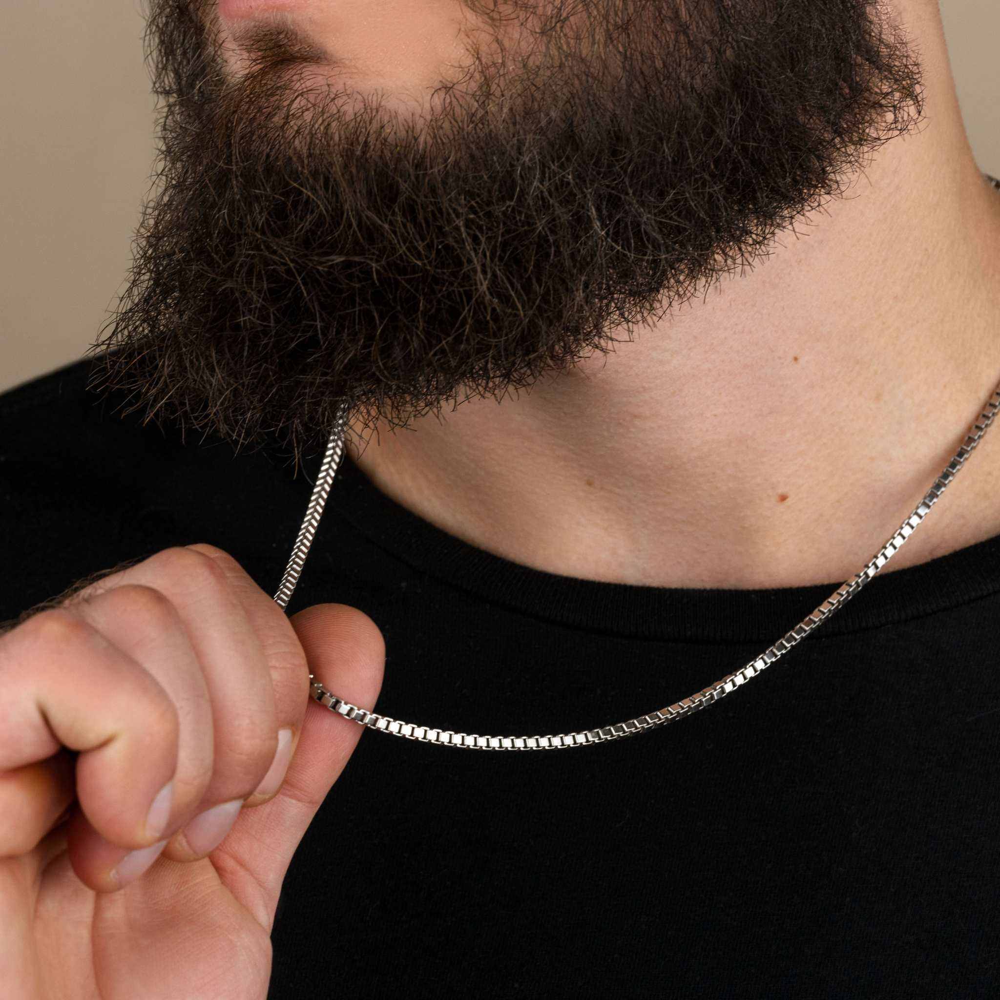 Sterling silver 925 box chain necklace worn by a person, featuring a modern squared design with lobster claw closure.