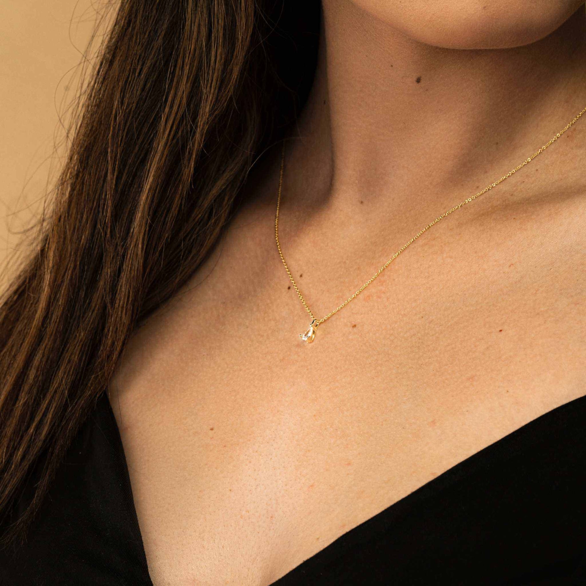 Delight Teardrop Necklace by Morf Jewelry on model showcasing pear-shaped diamond charm and 18K gold finish.