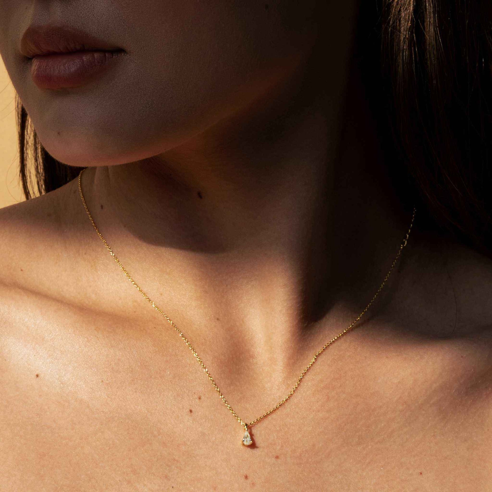 Teardrop Diamond Necklace in 18K Gold by Morf Jewelry on a model.