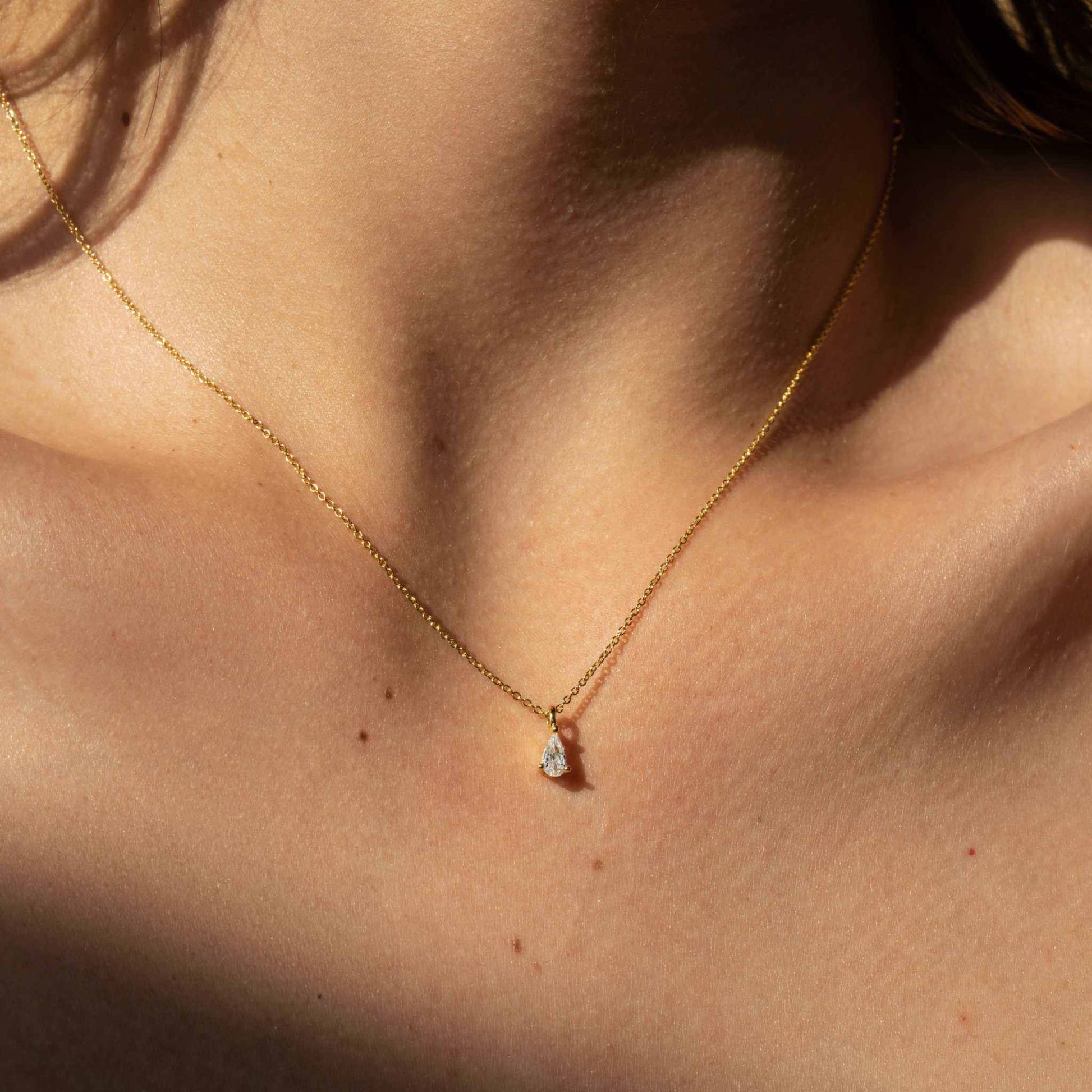 Delight Teardrop Necklace in 18K gold, featuring a pear-shaped diamond charm on a dainty sterling silver chain.