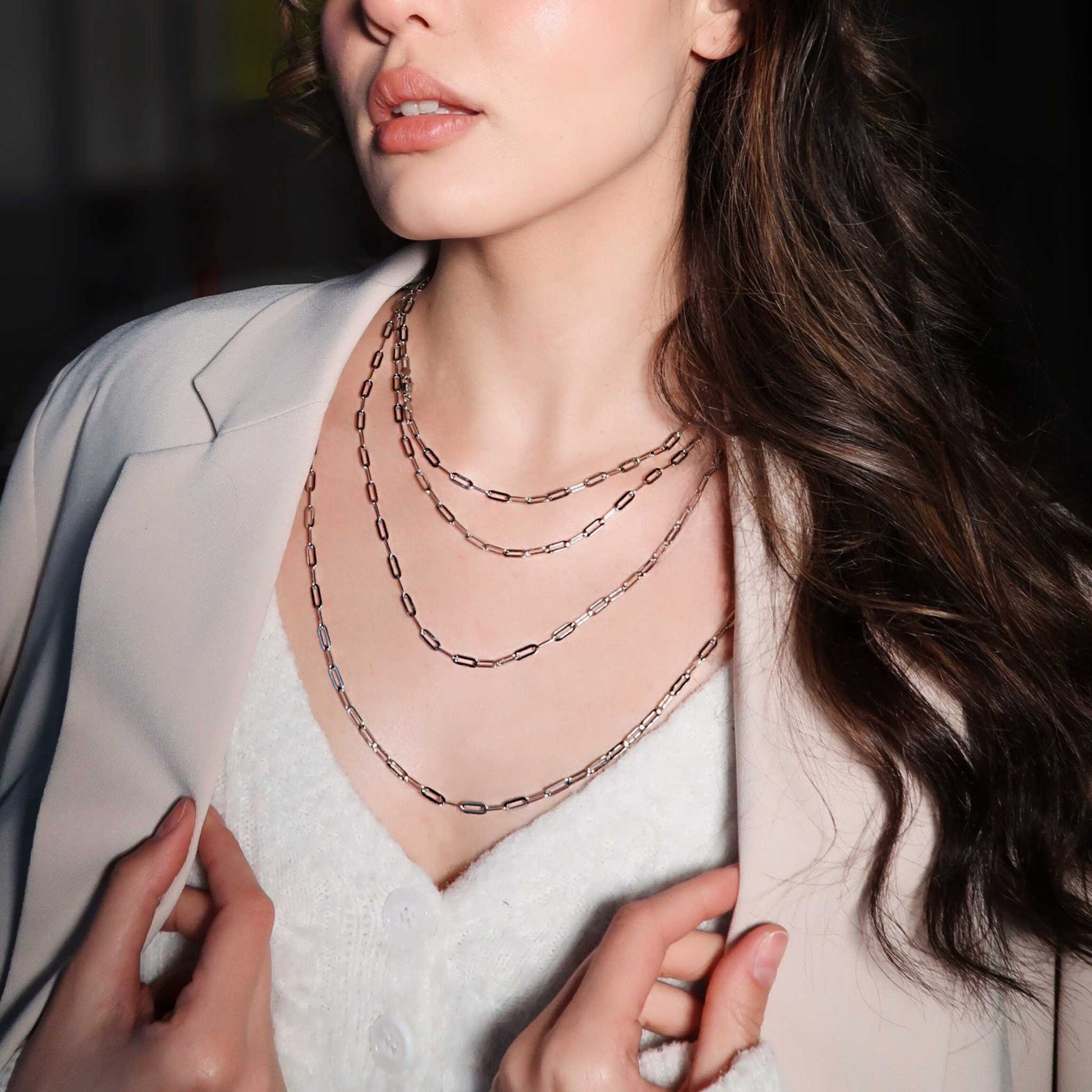 Dainty paperclip chain necklace in sterling silver worn by a woman, ideal for layering.