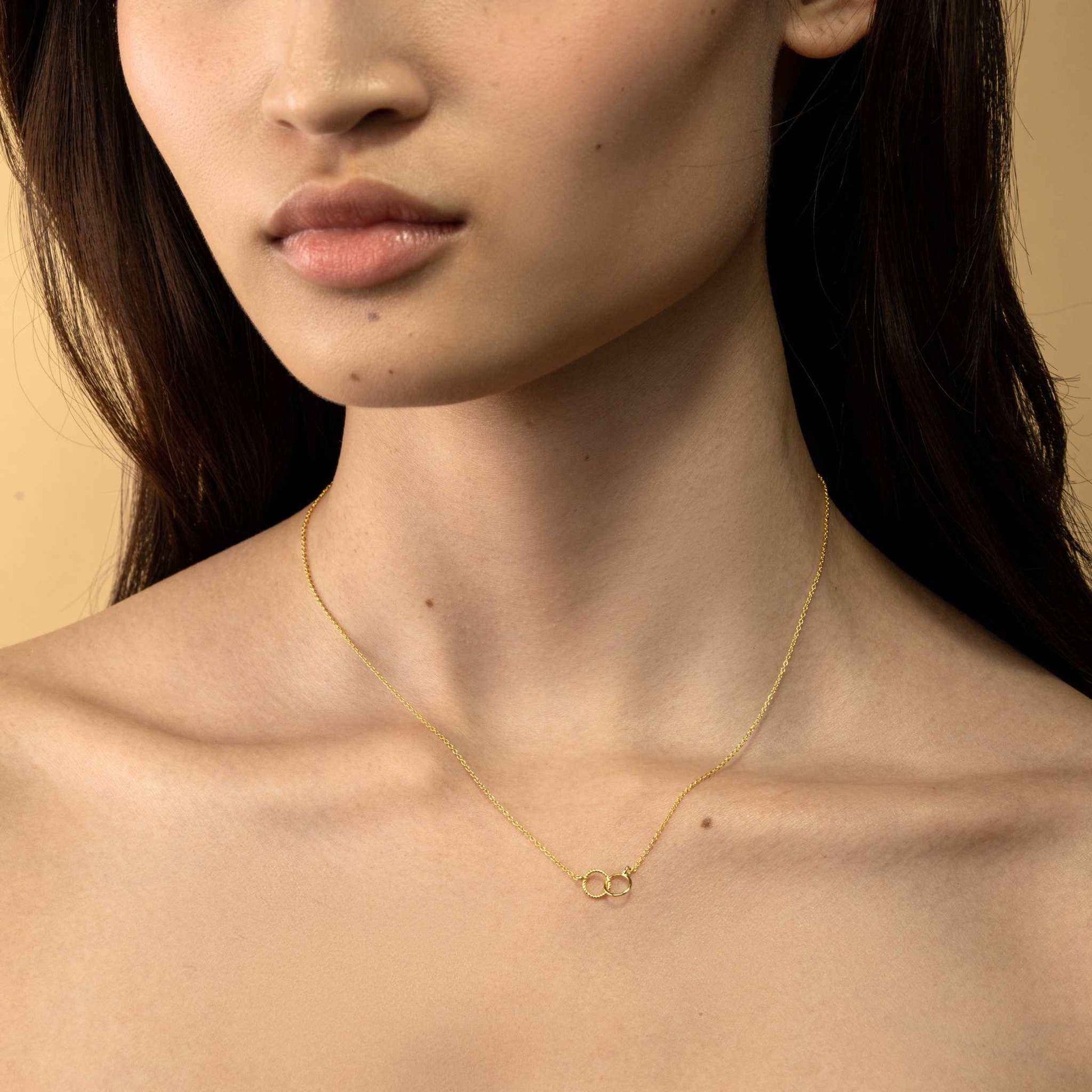 Dainty interlocking circle necklace in 14k gold on recycled sterling silver.