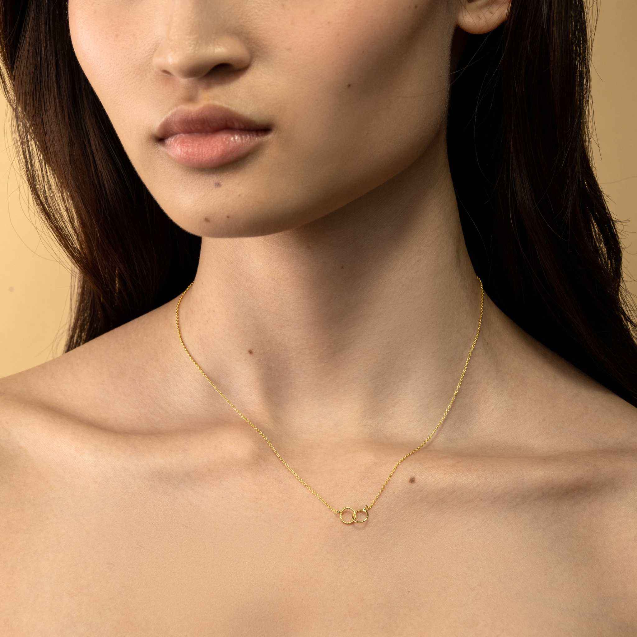 Dainty interlocking circle necklace in 14k gold on recycled sterling silver.