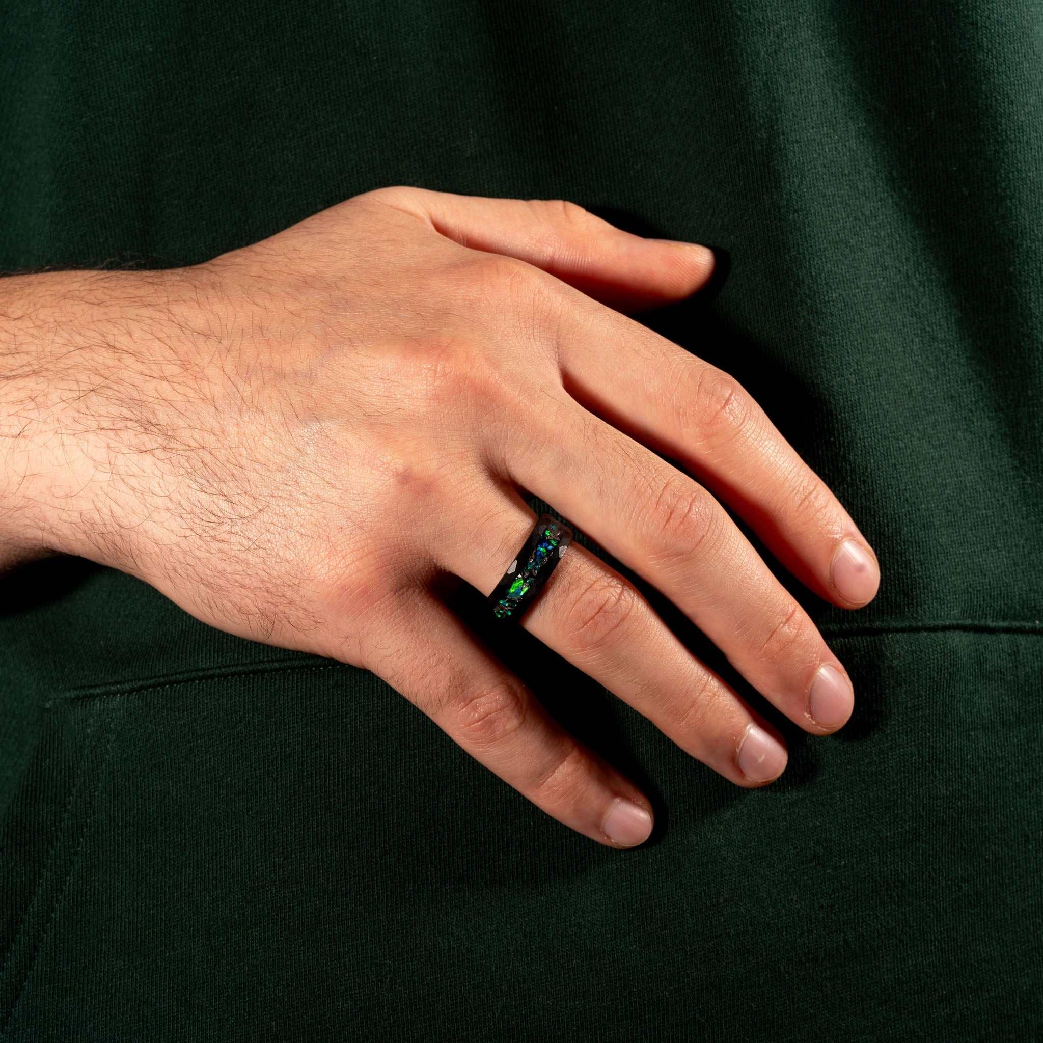 Meteorite & Green Opal Ring on finger, showcasing unique design and colors.