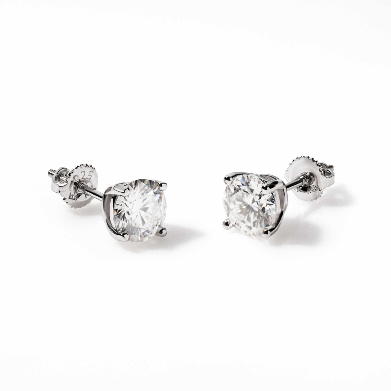Pair of round cut moissanite stud earrings in 925 sterling silver with screw back closure and 14K white gold plating.