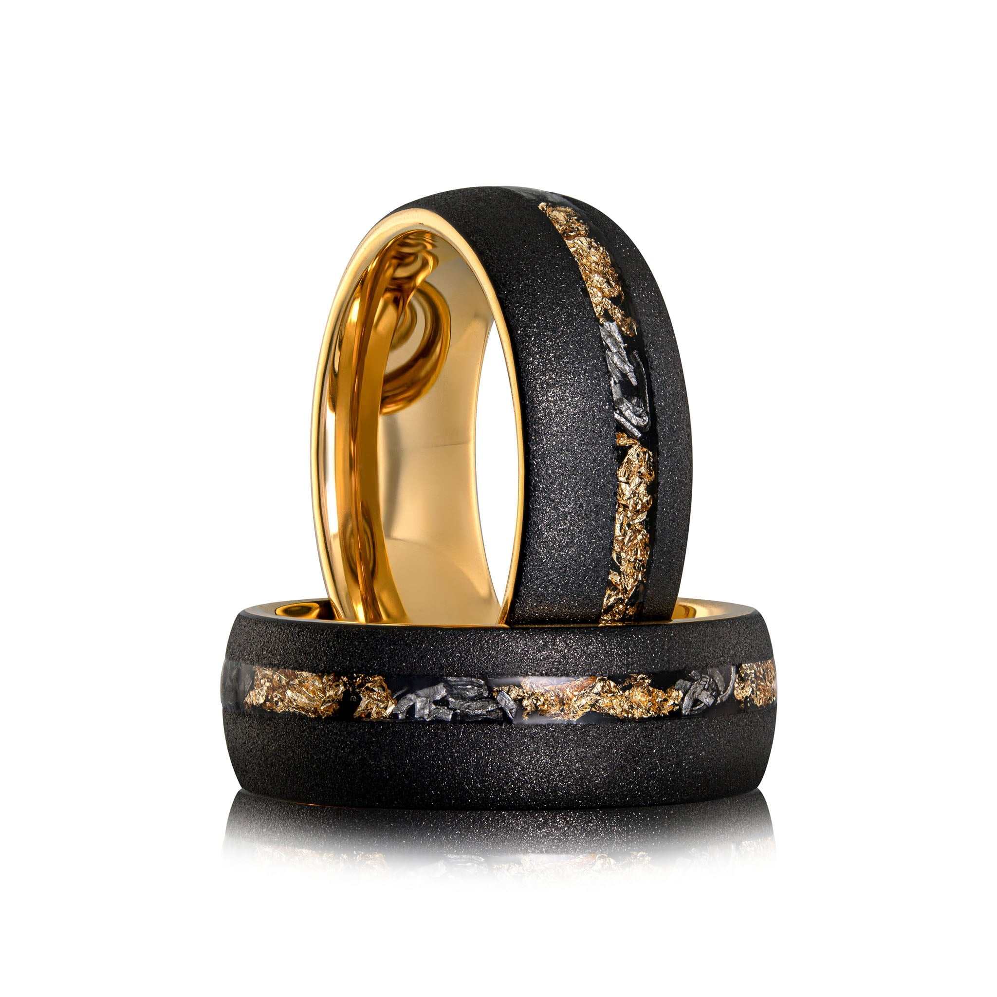 Sandblasted gold leaf meteorite ring with black band and gold interior.