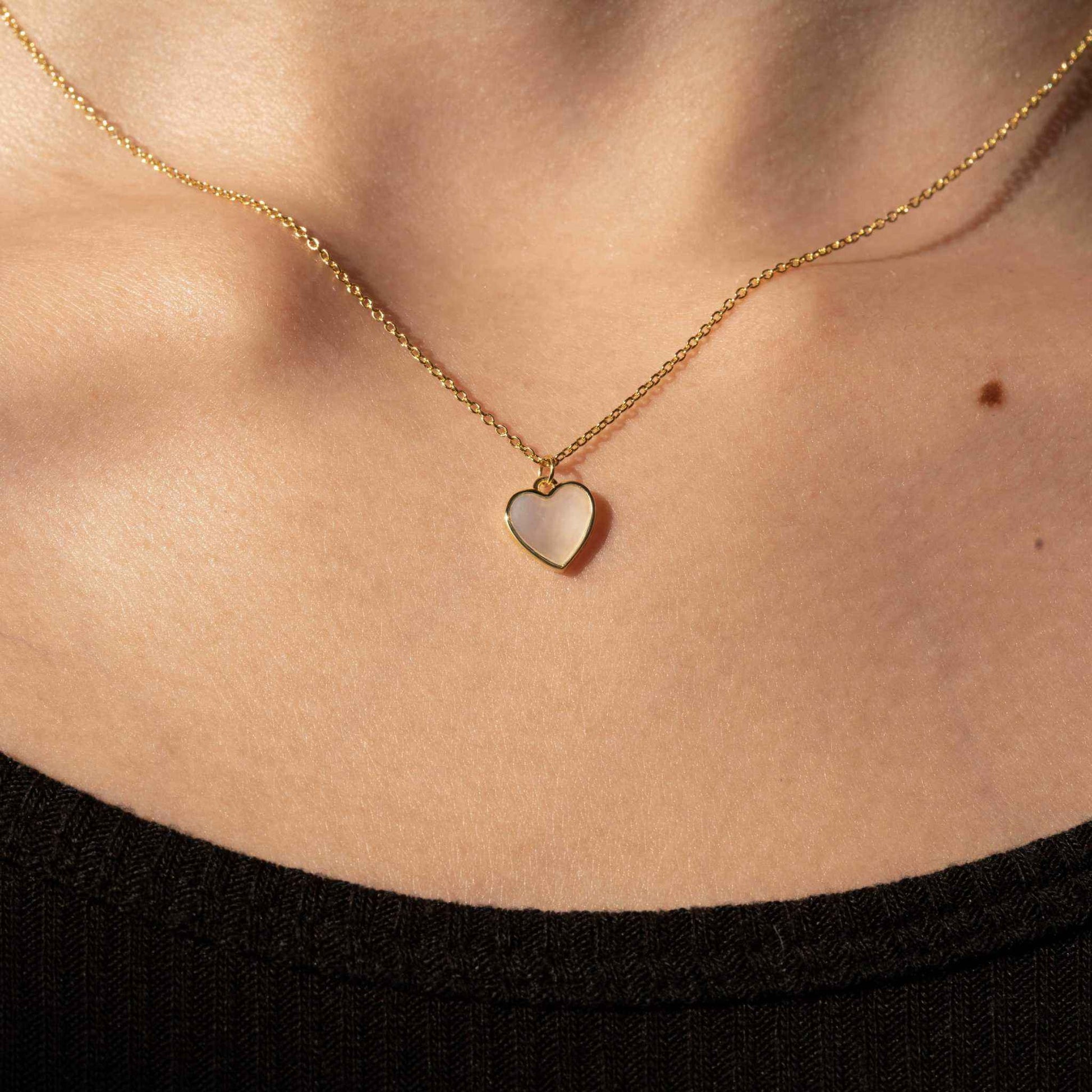 Seashell Serenity Necklace with heart-shaped mother of pearl pendant on 18K gold finish chain.